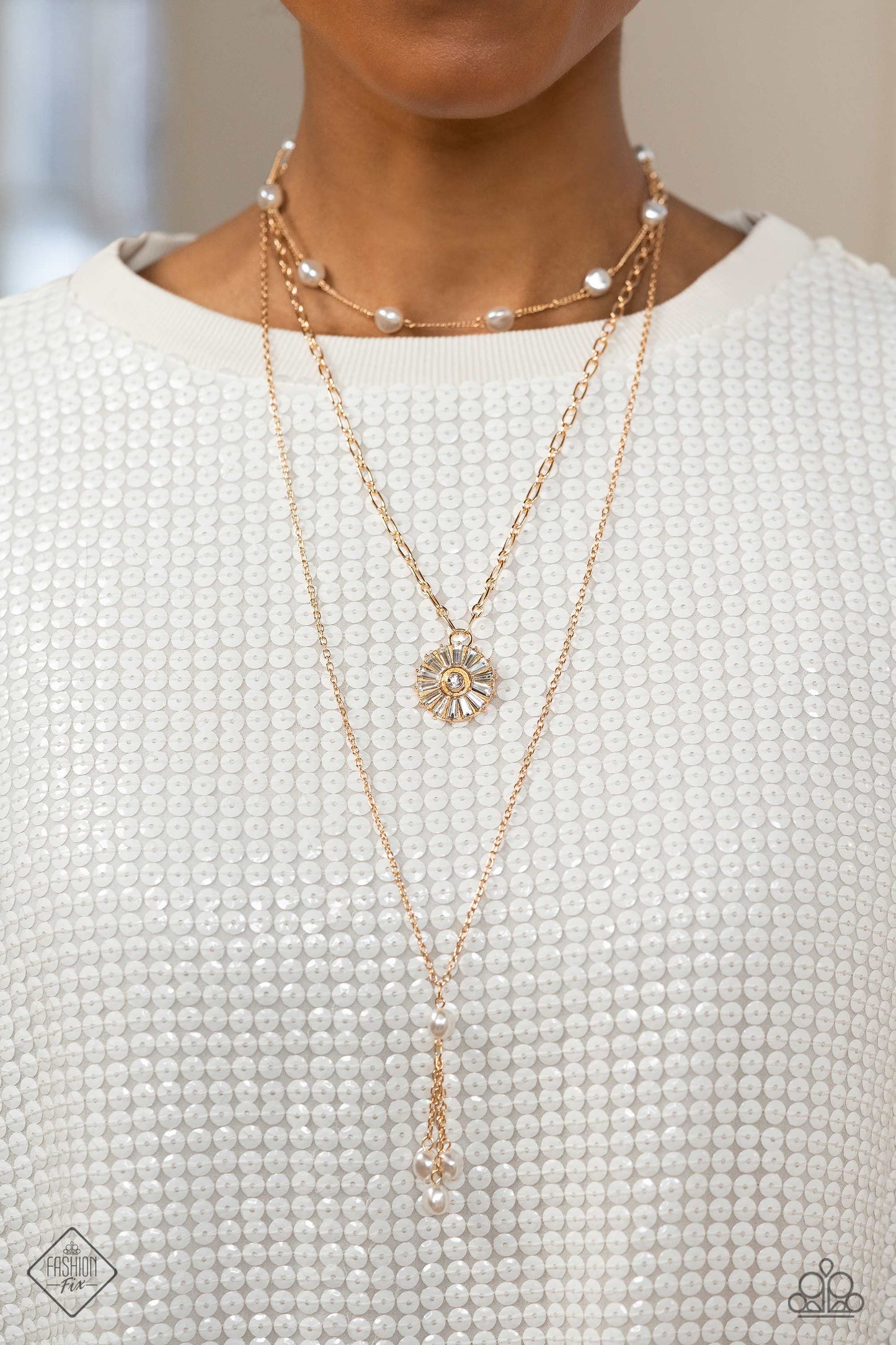 Paparazzi Accessories Audaciously Austen - Gold Three shimmery gold chains layer across the chest, with each strand featuring a different motif. Featured on the uppermost chain, white baroque pearls sporadically dot a dainty gold chain. Below it, a gold p