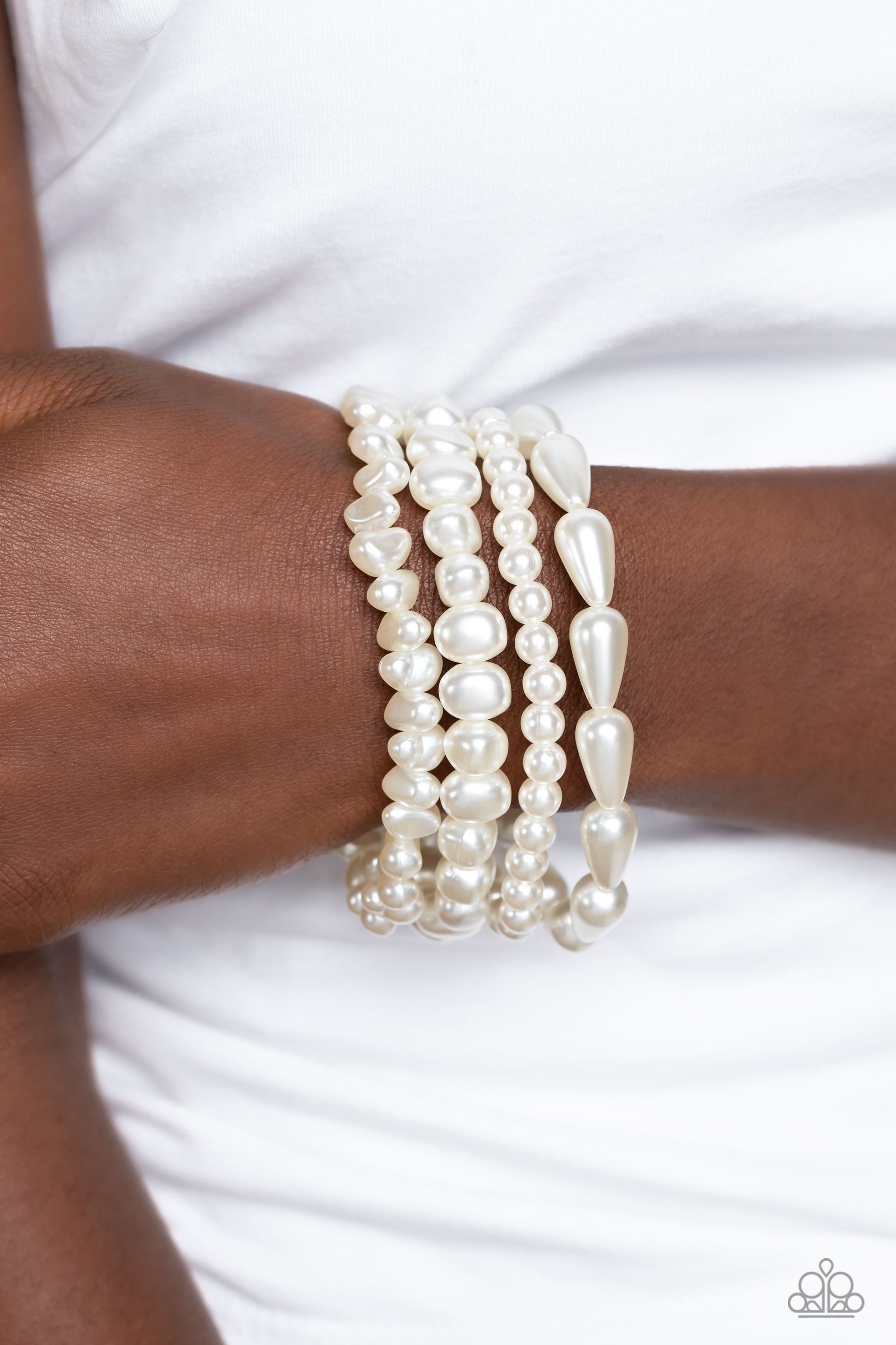 Paparazzi Accessories Gossip PEARL - White An abstract collection of geometric white pearls coalesces around the wrist in four layers on elastic stretchy bands for a fashionably, refined stack. Sold as one individual bracelet. Jewelry
