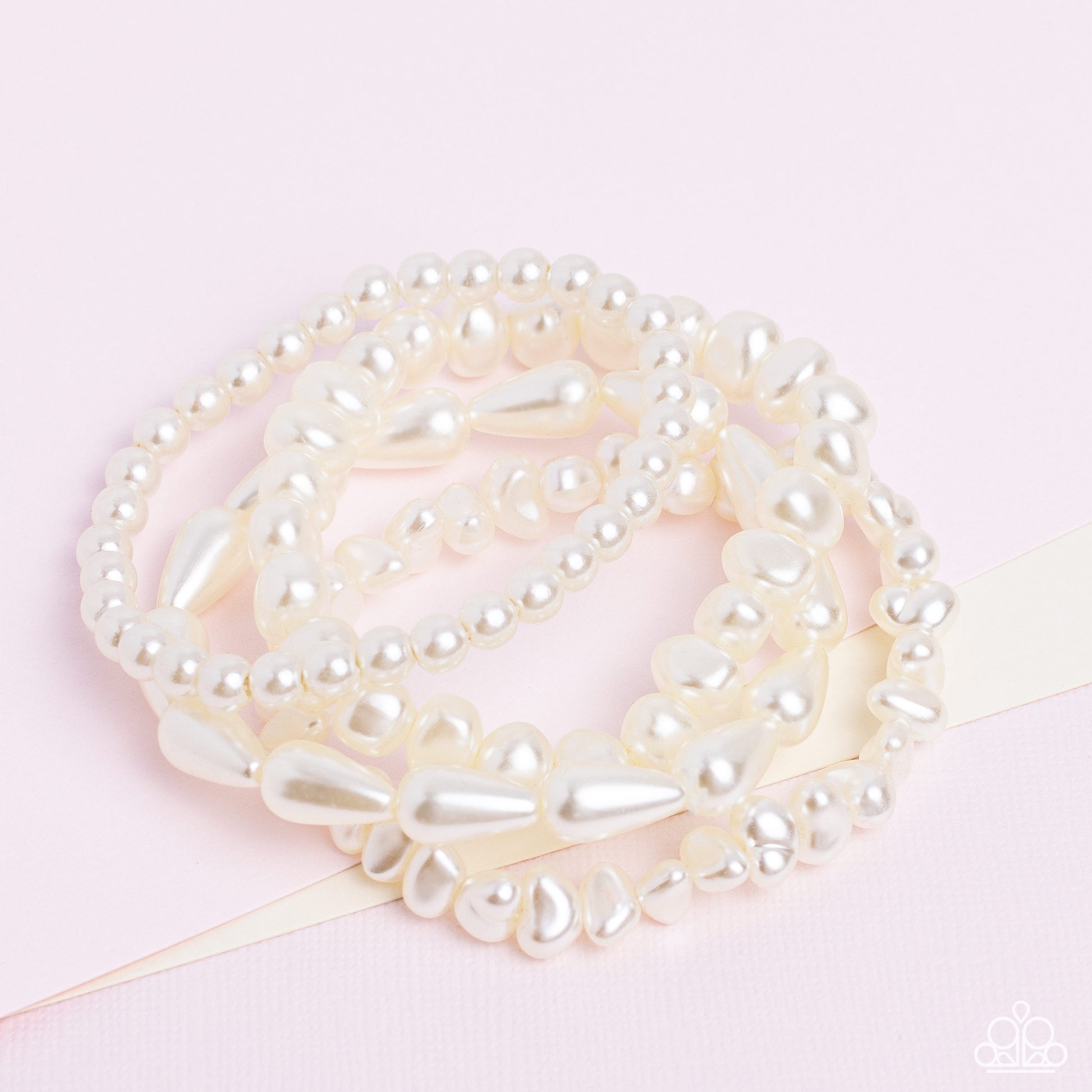 Paparazzi Accessories Gossip PEARL - White An abstract collection of geometric white pearls coalesces around the wrist in four layers on elastic stretchy bands for a fashionably, refined stack. Sold as one individual bracelet. Jewelry