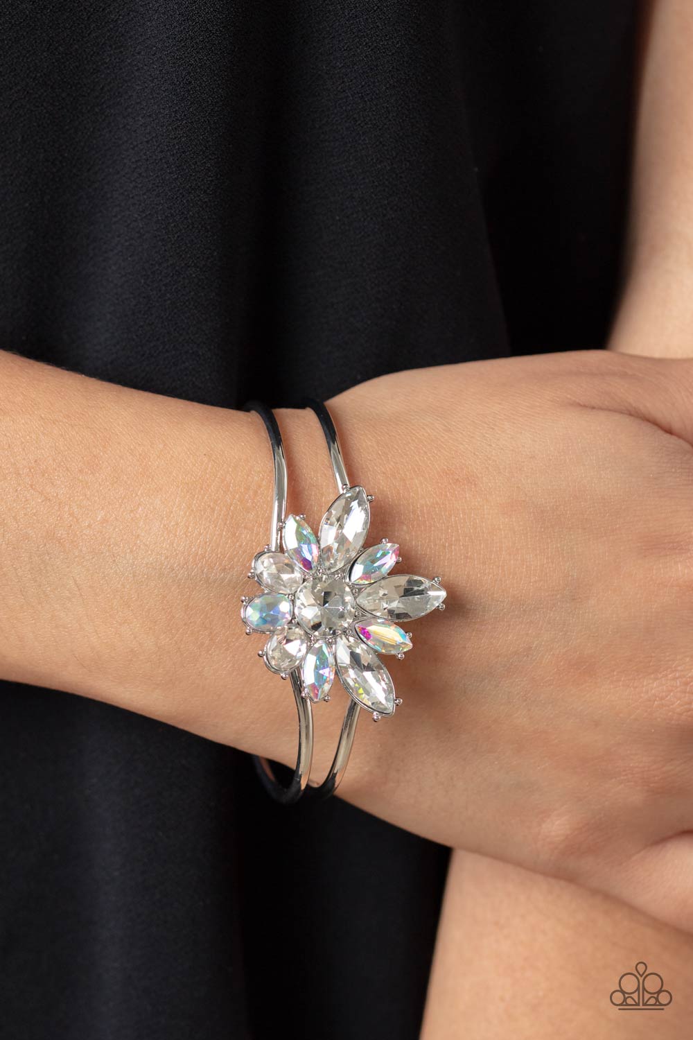 Paparazzi Accessories Chic Corsage - White Varying sizes of oval and marquise-cut gems in shades of crystal white and shimmery iridescent bloom around a round-brilliant cut center in a similar crystal white hue. The dazzling collection of sparkly petals c
