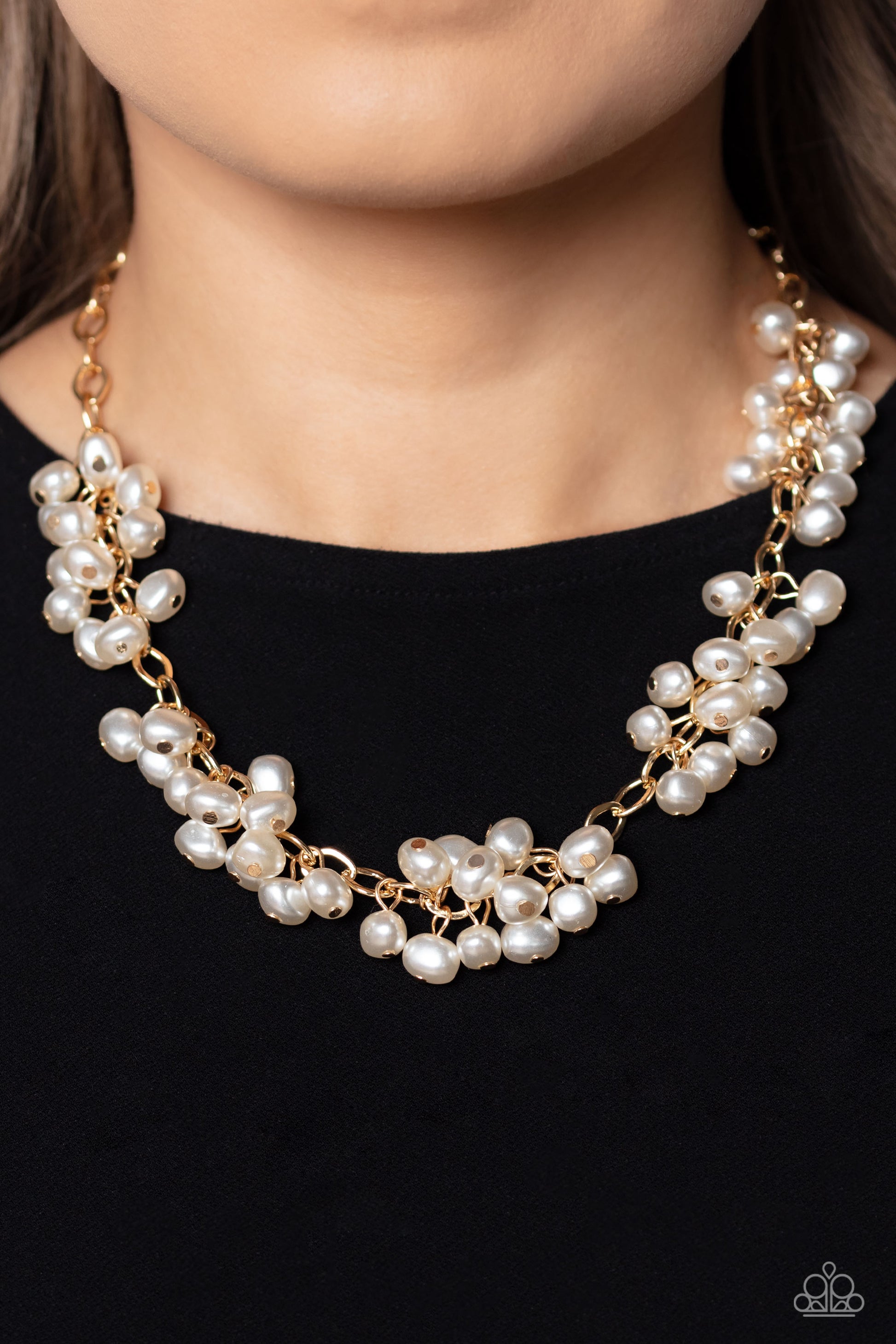 Paparazzi Accessories Pearl Parlor - Gold A cascade of classic white pearly beads dangle from a high-sheen gold, oval linked chain. The pearly beads cluster across the neckline, creating a refined pop of color. Features an adjustable clasp closure. Sold a