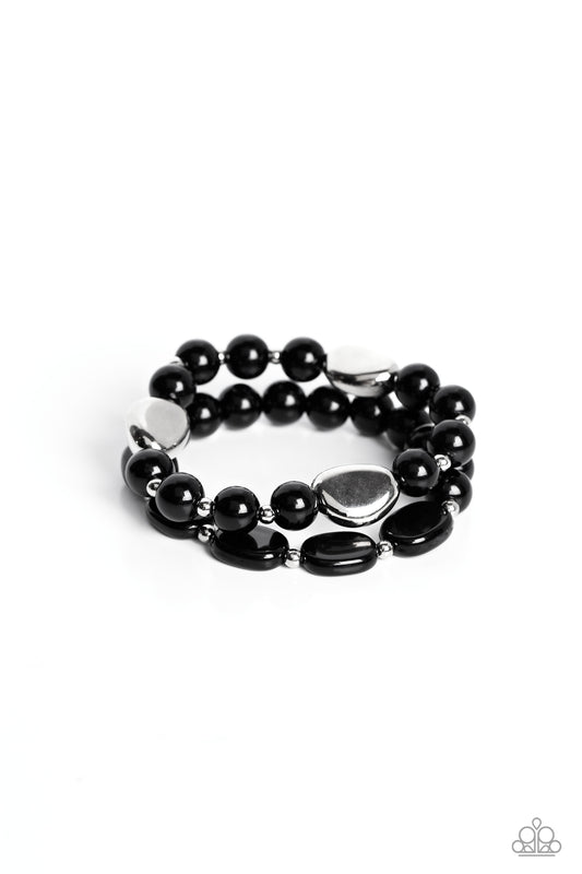Paparazzi Accessories Roadhouse Renegade - Black A collection of round and flat black beads, silver accents and concaved silver beads are threaded along stretchy bands around the wrist, creating colorful layers. Sold as one set of two bracelets. Jewelry