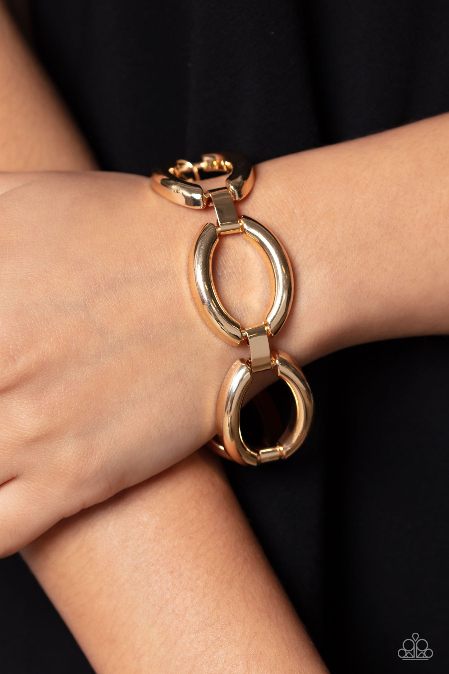 Paparazzi Accessories Constructed Chic - Gold Abstract gold ovals, linked together by moveable gold clasps, link around the wrist for a high-sheen, industrial finish. Features an adjustable clasp closure. Sold as one individual bracelet. Jewelry