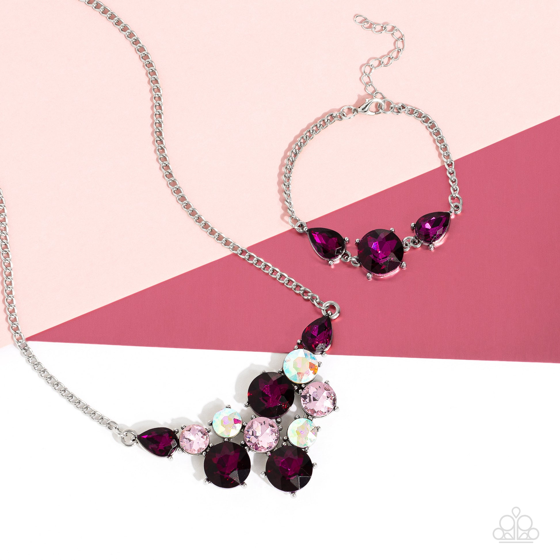 Paparazzi Accessories Twinkling Trio - Pink An oversized round gem bordered by teardrop gems cluster together to create a glittery silver collection around the wrist. Featured in a fuchsia hue, each gem reflects light off of its faceted surface emitting f
