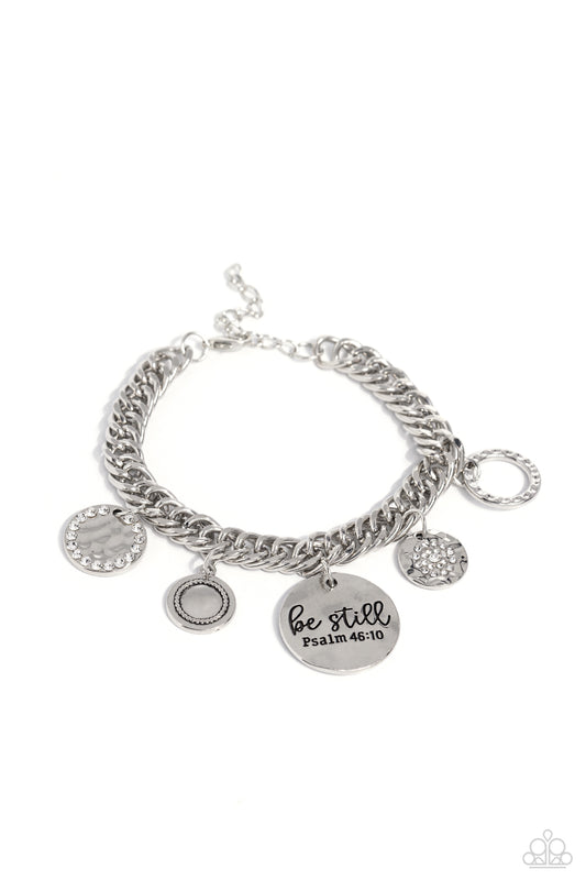 Paparazzi Accessories GLITTER and Grace - White Gliding from a thick silver curb chain, a collection of refined charms add some texture and shimmer to this monochromatic mash-up. An oversized, hammered disc is stamped with the phrase "be still" with the s