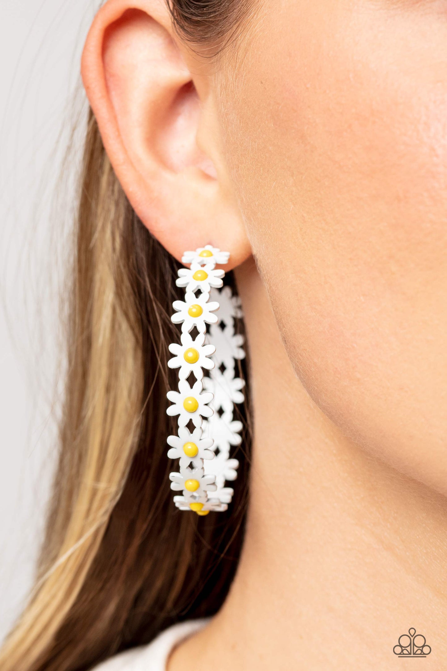 Paparazzi Accessories Daisy Disposition - White A dainty collection of white daisies with yellow centers blooms into a free-spirited hoop around the ear. Earring attaches to a standard post fitting. Hoop measures approximately 2" in diameter. Sold as one