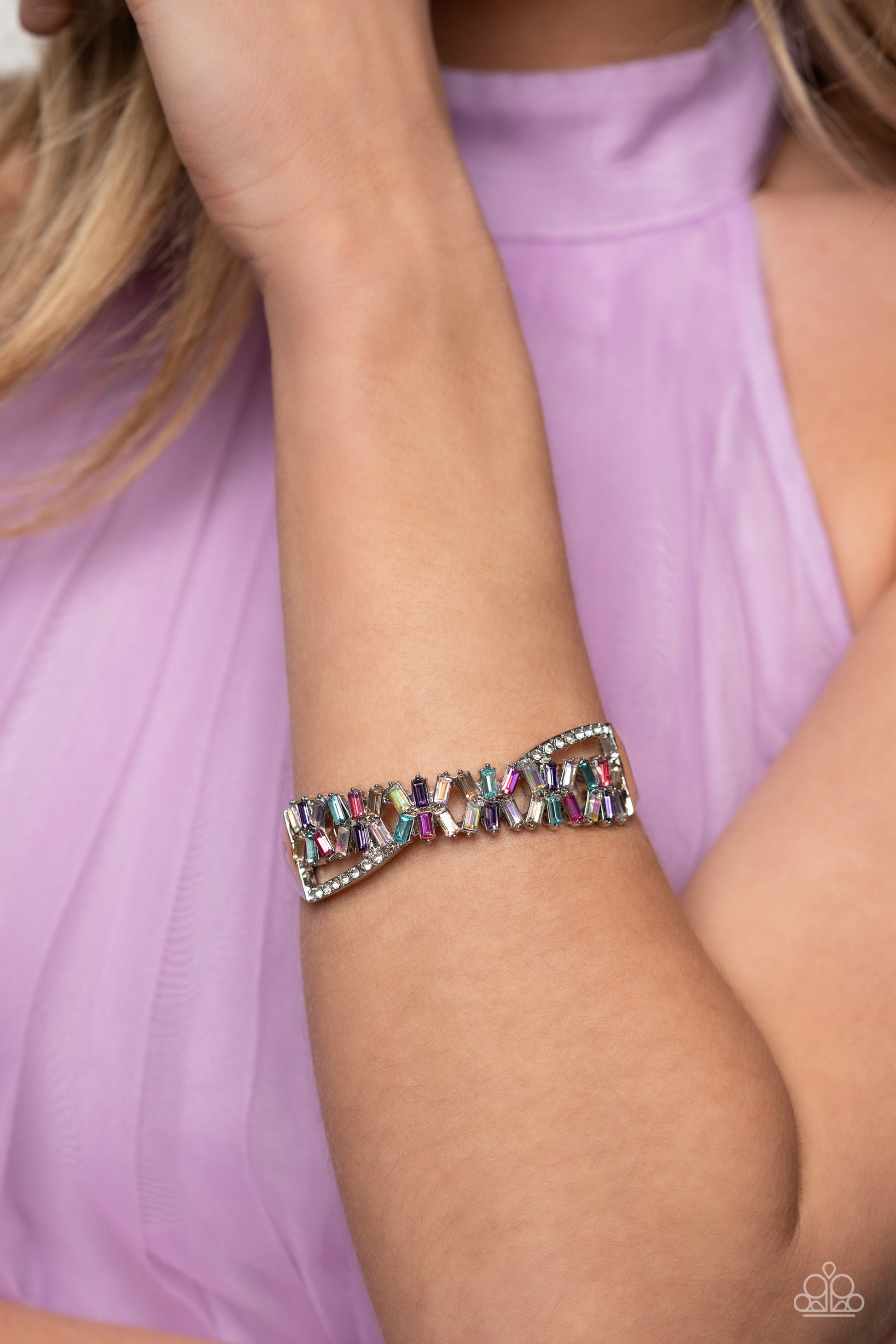 Paparazzi Accessories Timeless Trifecta - Multi Modeled after the infinity symbol curves, a row of dainty white rhinestones playfully interacts with emerald-cut gems splashed in shades of amethyst, light blue, pink, smoked topaz, and iridescence. Set in c
