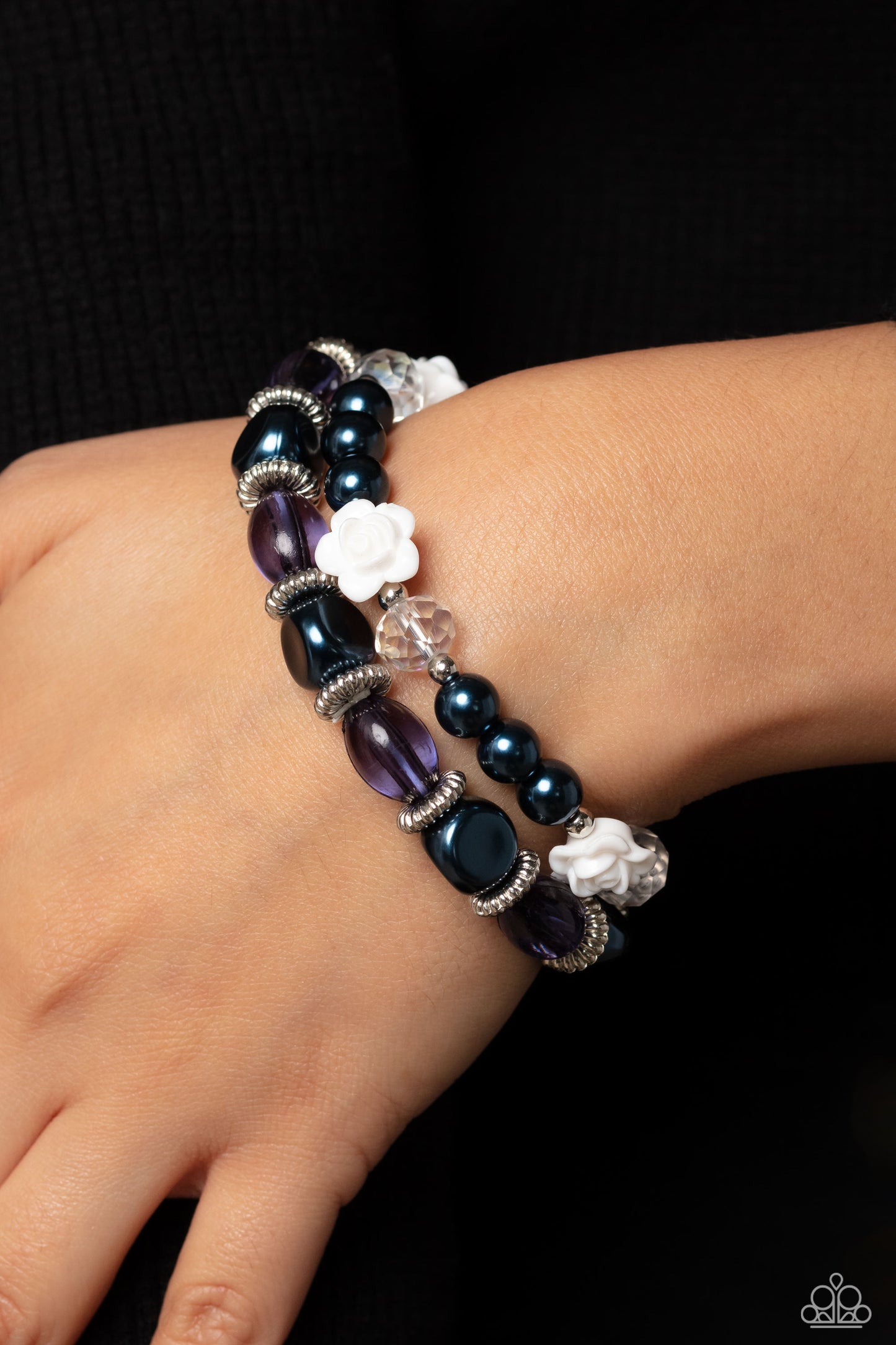 Paparazzi Accessories Who ROSE There? - Blue Montana pearls, silver studded rings, varying shapes of Montana and clear blue beads, silver accents, faceted clear beads, and white resin roses stretch across elastic stretchy bands around the wrist for a refi