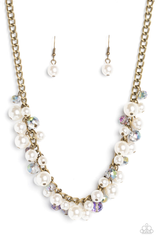 Paparazzi Accessories Glinting Goddess - Brass A faceted collection of glassy, UV reflective crystal-like beads and classic white pearls in varying sizes flickers and flashes below the collar on a thick brass curb chain for a refined shimmer. Features an