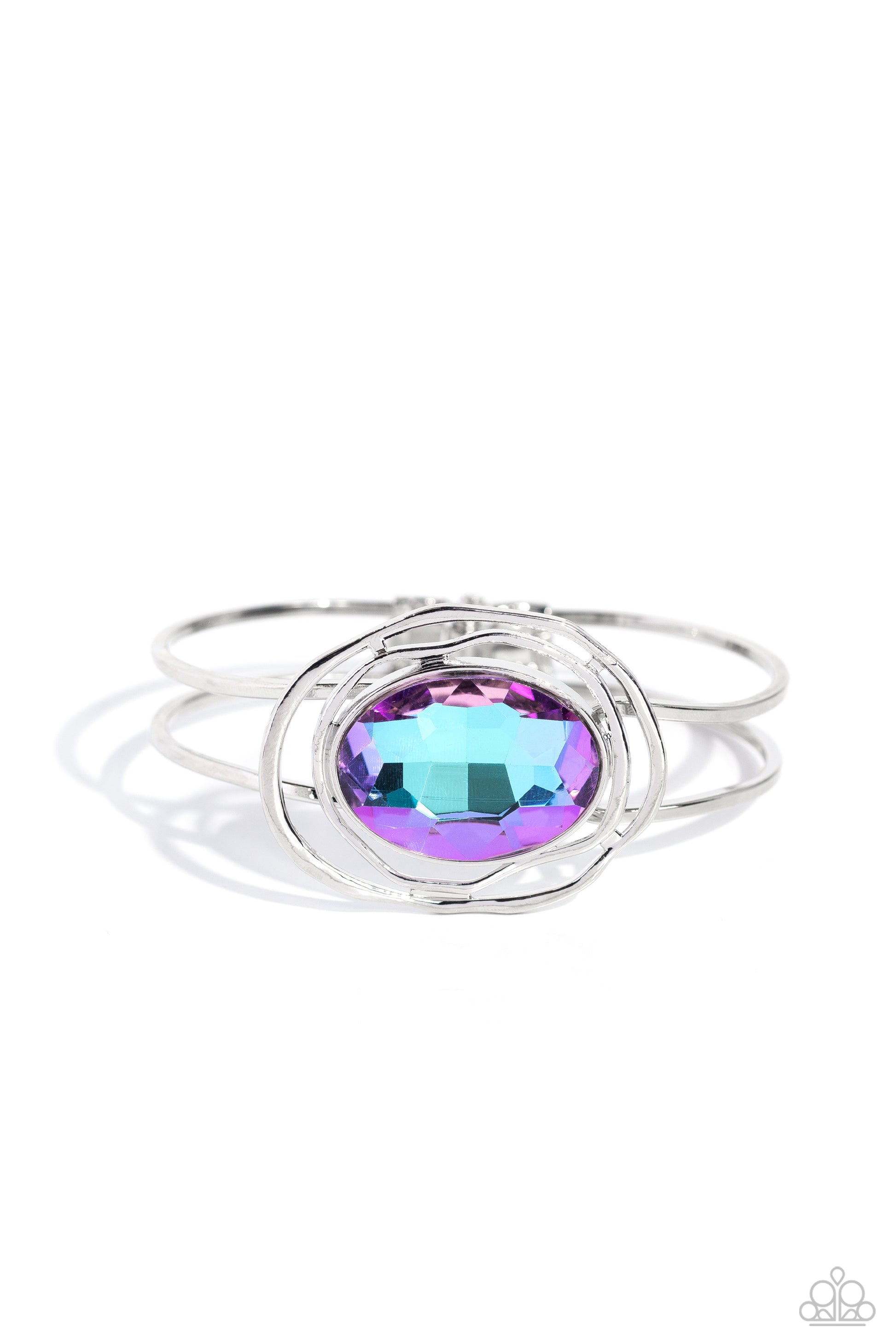 Paparazzi Accessories Substantial Sorceress - Purple Featured in the center of airy, shiny silver bands, an oversized, faceted purple oval gem rests atop the wrist for a dazzling pop of color. Warped, shiny silver rings seemingly float around the sparkly