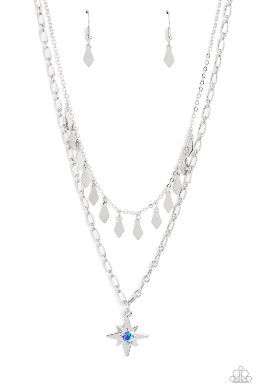 Paparazzi Accessories The Second Star To The LIGHT - Blue A three-dimensional silver star, dotted with a single blue-iridescent rhinestone glides on a paperclip chain down the neckline for an out of-this-world vibe. Flat and flared silver frames dance abo