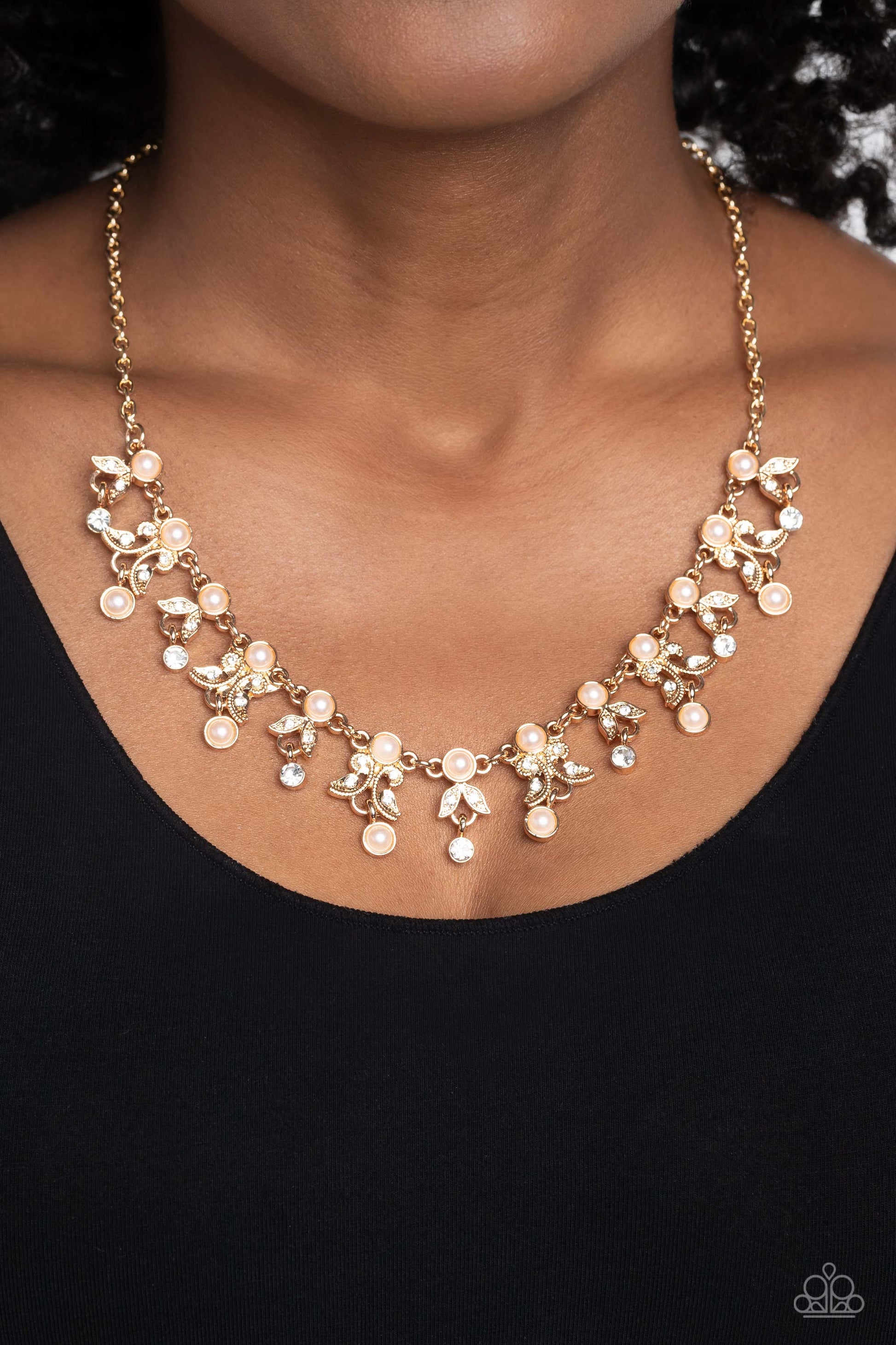 Paparazzi Accessories Garden Princess - Gold Infused along a classic gold chain, a row of pearls, pressed into gold frames, stands out against the collar for a touch of refinement. Dangling below the row of pearls, a shimmery collection of leaf-like filig