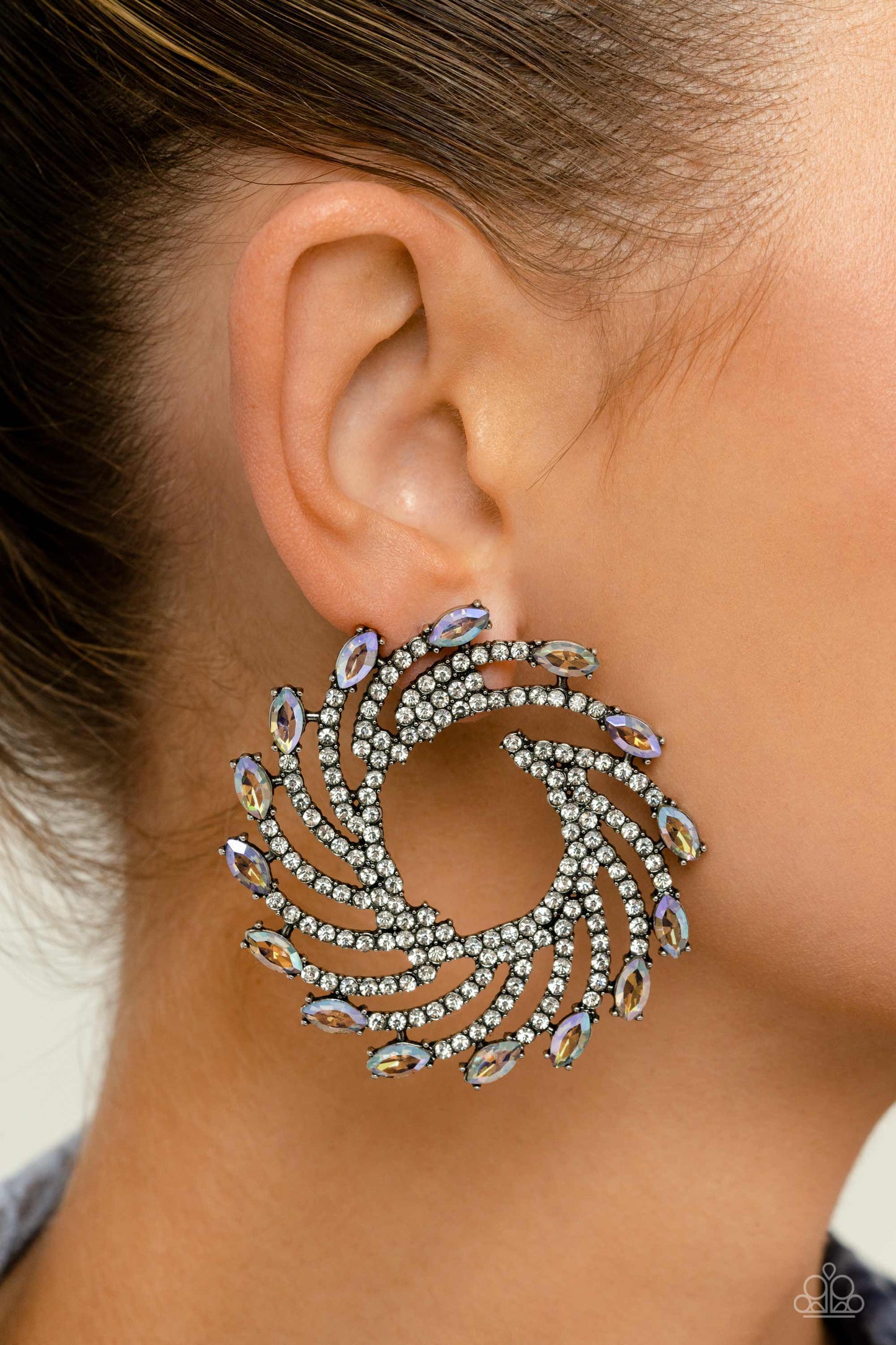 Paparazzi Accessories Firework Fanfare - Multi Shimmery strands of silver spin out from an airy center, creating an exaggerated firework-like display at the ear. An explosion of dainty white rhinestones lines the swirls and curves of the shimmery display