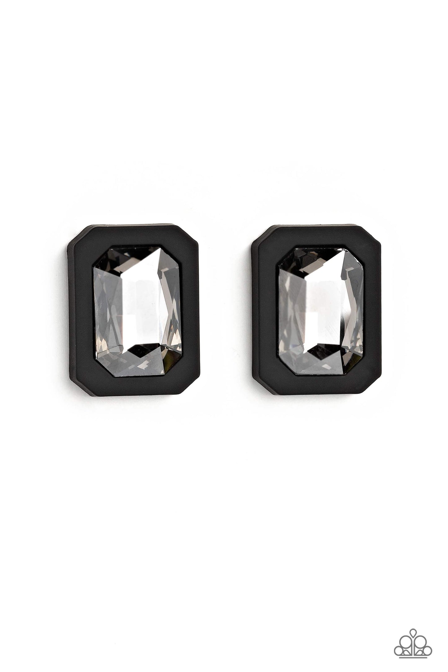 Paparazzi Accessories Edgy Emeralds - Black Standing out against a black rubber backdrop, an oversized, faceted emerald-cut gem shimmers and shines for an edgy sparkle against the ear. Earring attaches to a standard post fitting. Sold as one pair of post