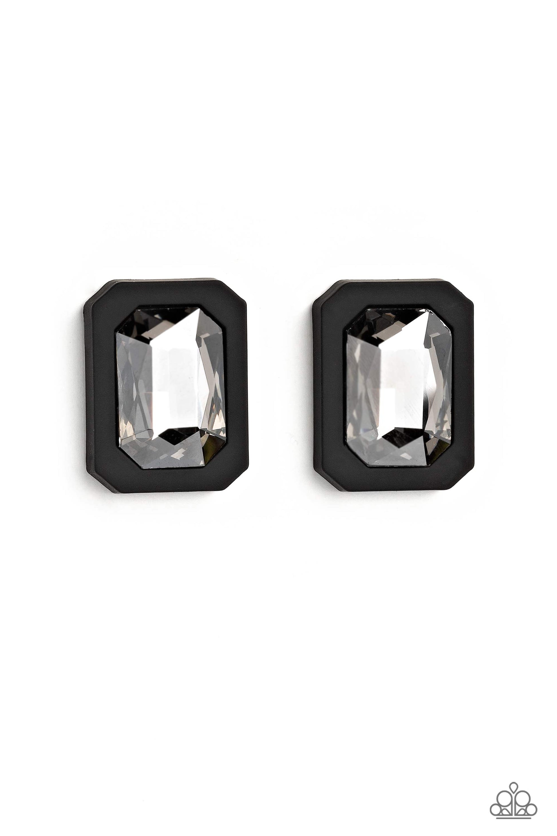 Paparazzi Accessories Edgy Emeralds - Black Standing out against a black rubber backdrop, an oversized, faceted emerald-cut gem shimmers and shines for an edgy sparkle against the ear. Earring attaches to a standard post fitting. Sold as one pair of post