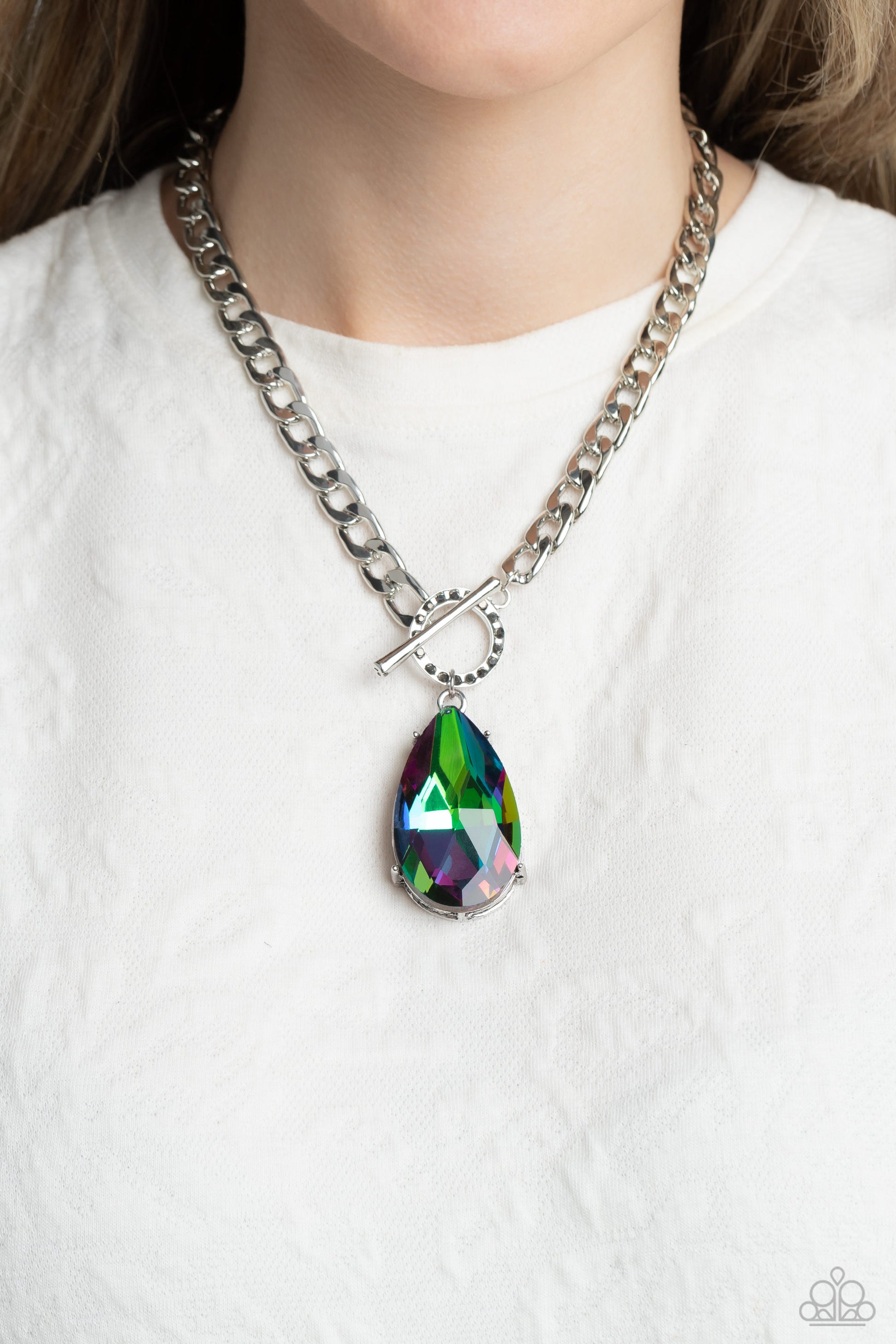 Paparazzi Accessories Edgy Exaggeration - Multi Featuring an elegant lariat closure, an oversized, faceted, stellar UV shimmery teardrop gem, encased in an elevated pronged silver frame cascades from the bottom of a silver curb chain in a whimsical fashio