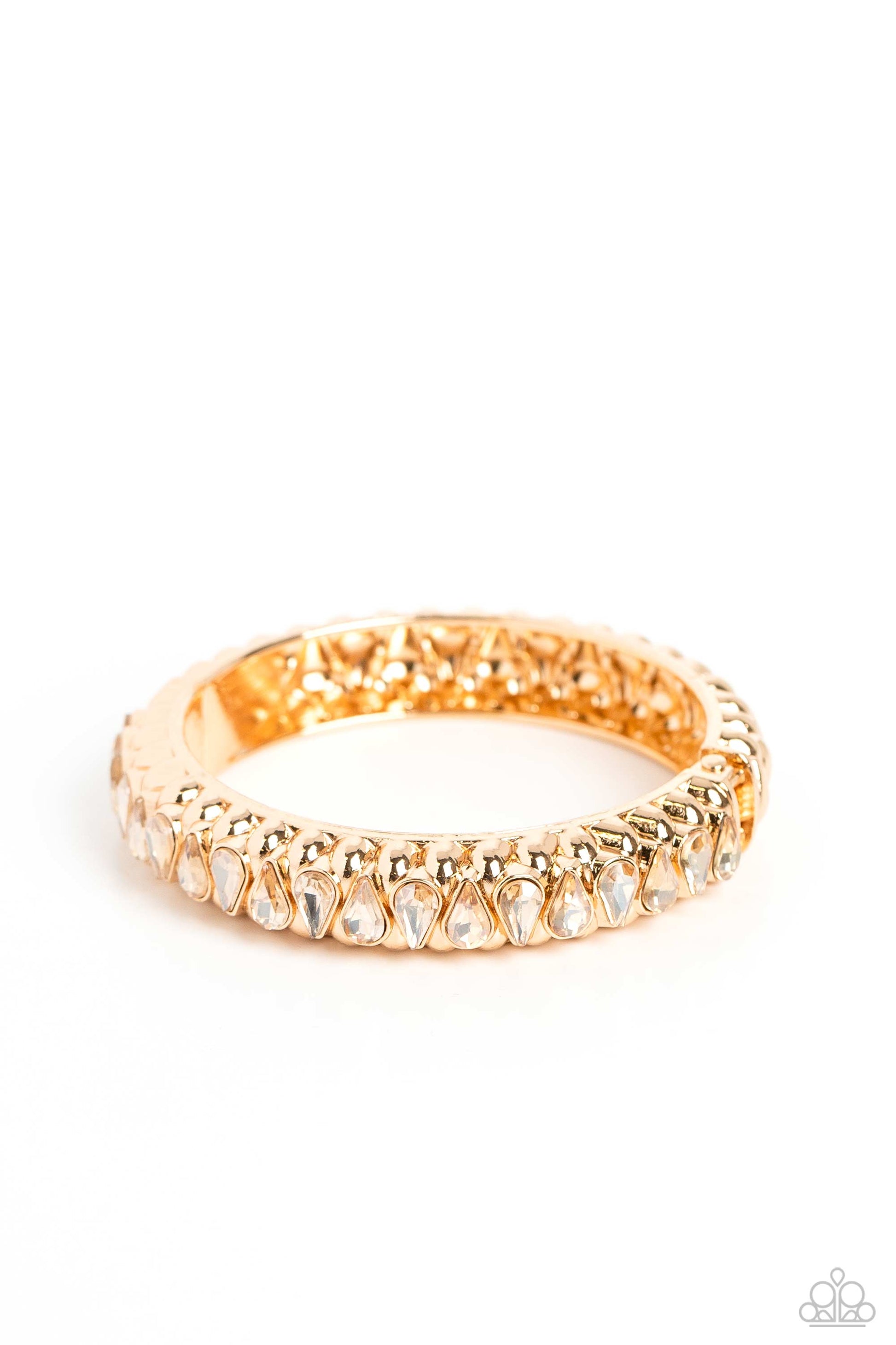 Paparazzi Accessories Crafted Coals - Gold A thick band of gold is embossed in a teardrop-shaped texture, as it wraps around the wrist to create a bold bangle with a hinged closure. A shock of sparkle adorns one side of the design, as glamorous teardrop-s