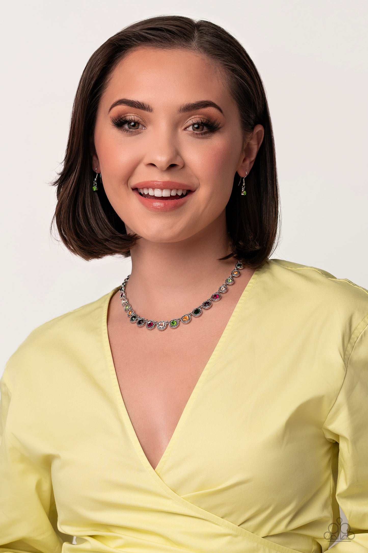 Paparazzi Accessories Kaleidoscope Charm - Multi Spanning around the entirety of the neckline, a refined collection of colorful rhinestones are pressed into airy, studded, silver square frames, tilted on their sides for a three-dimensional shimmer. The fr