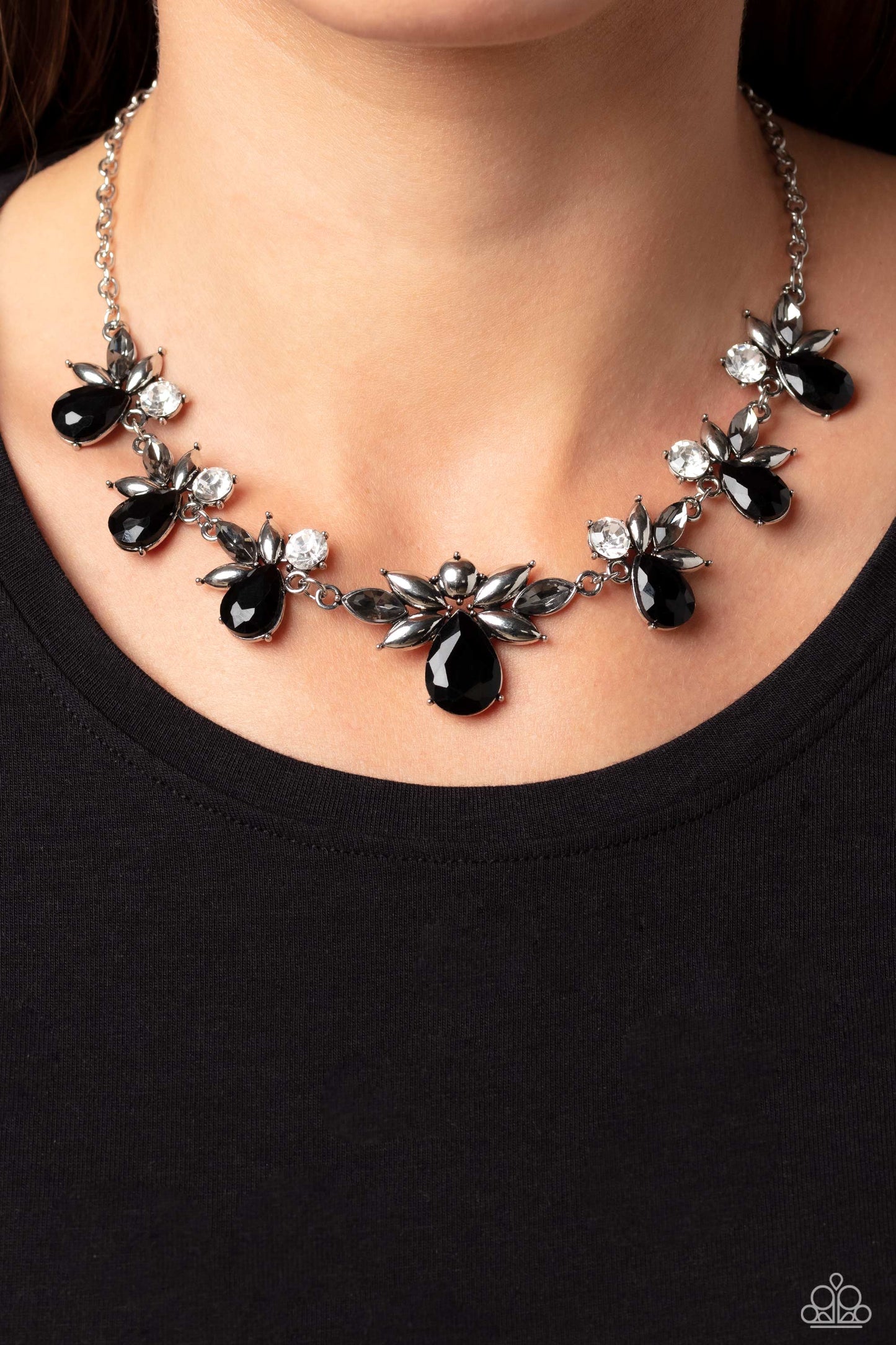 Paparazzi Accessories Explosive Effulgence - Black Black teardrops with explosions of white gems, and smoky marquise-cut gems fanning around it, elegantly trickle into refined clusters along a shimmery silver chain, creating a timeless geometric palette.