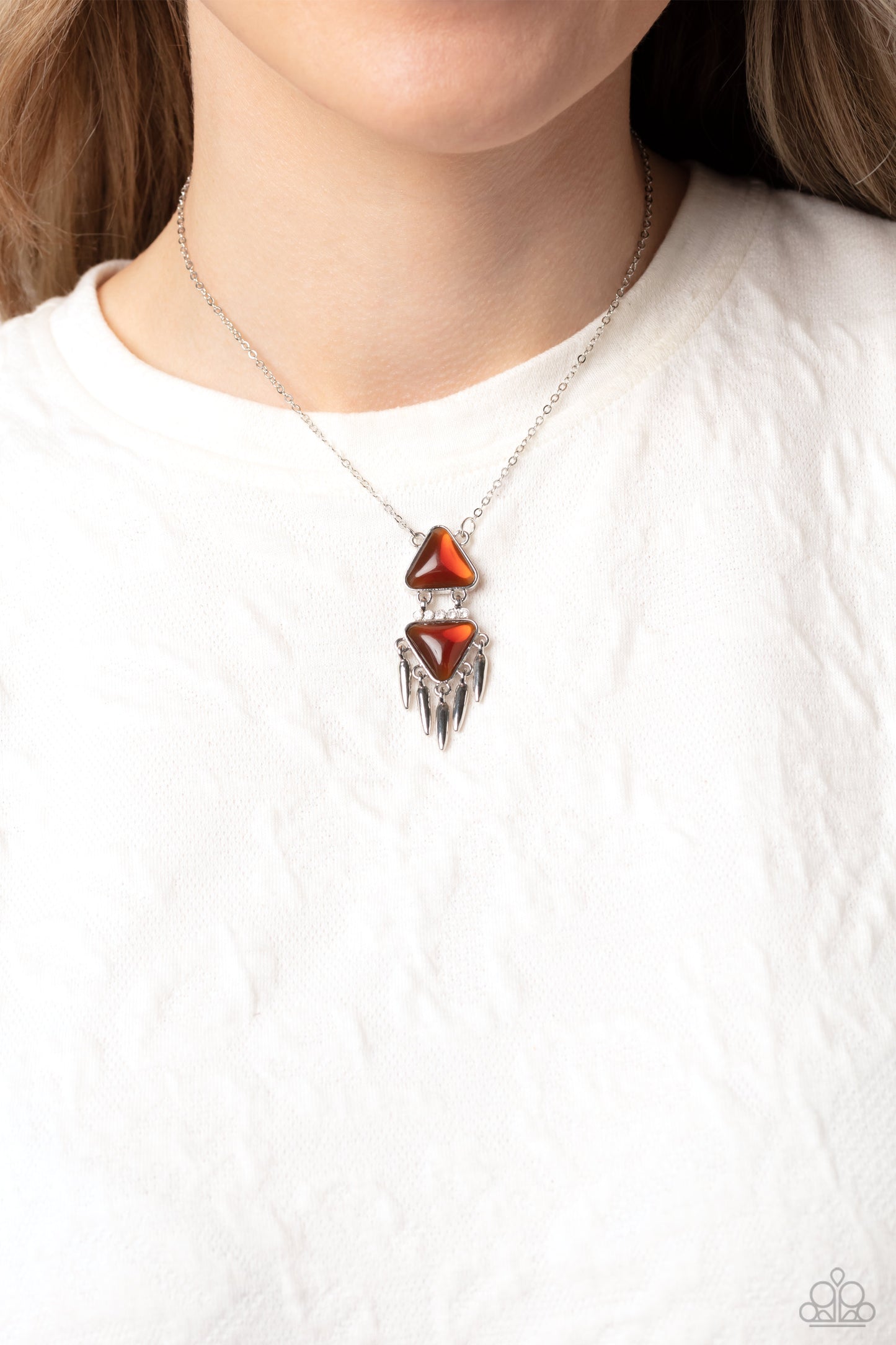Paparazzi Accessories Under the FRINGE - Brown A dainty brown opalescent triangle stacks onto a similar-sized, upside down triangle in the same hue, creating an edgy geometric silver pendant. Encrusted along the airy space between the two triangles, a row