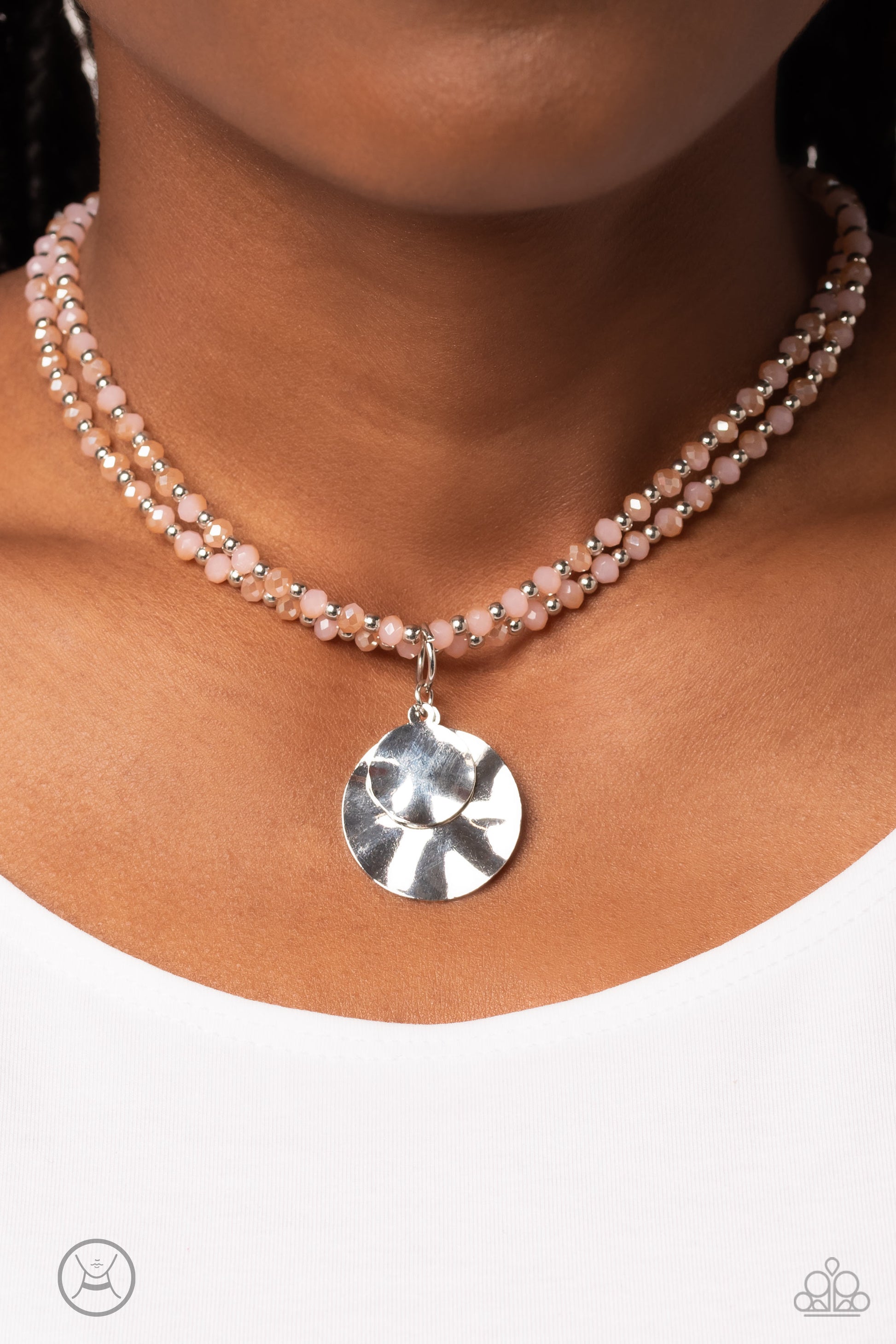 Paparazzi Accessories Compacted Cosmos - Pink Two strands of faceted pink beads, brushed in a pink reflective coating, alternate with silver studs as they coalesce around the collar for a vibrant pop of color. Two hammered silver discs in varying sizes da