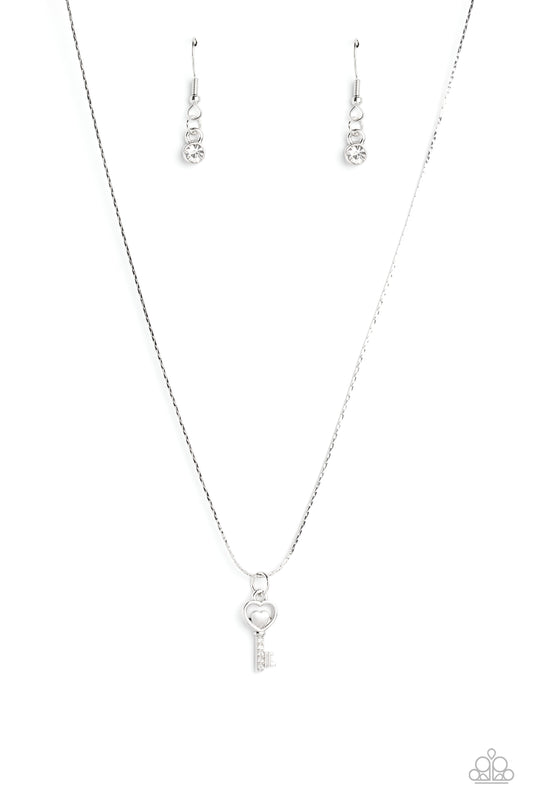 Paparazzi Accessories LOVE-Locked - White Dotted with glittery white rhinestones, a key pendant with a heart outline swings from the bottom of a dainty silver chain for a whimsical look. Features an adjustable clasp closure. Sold as one individual necklac