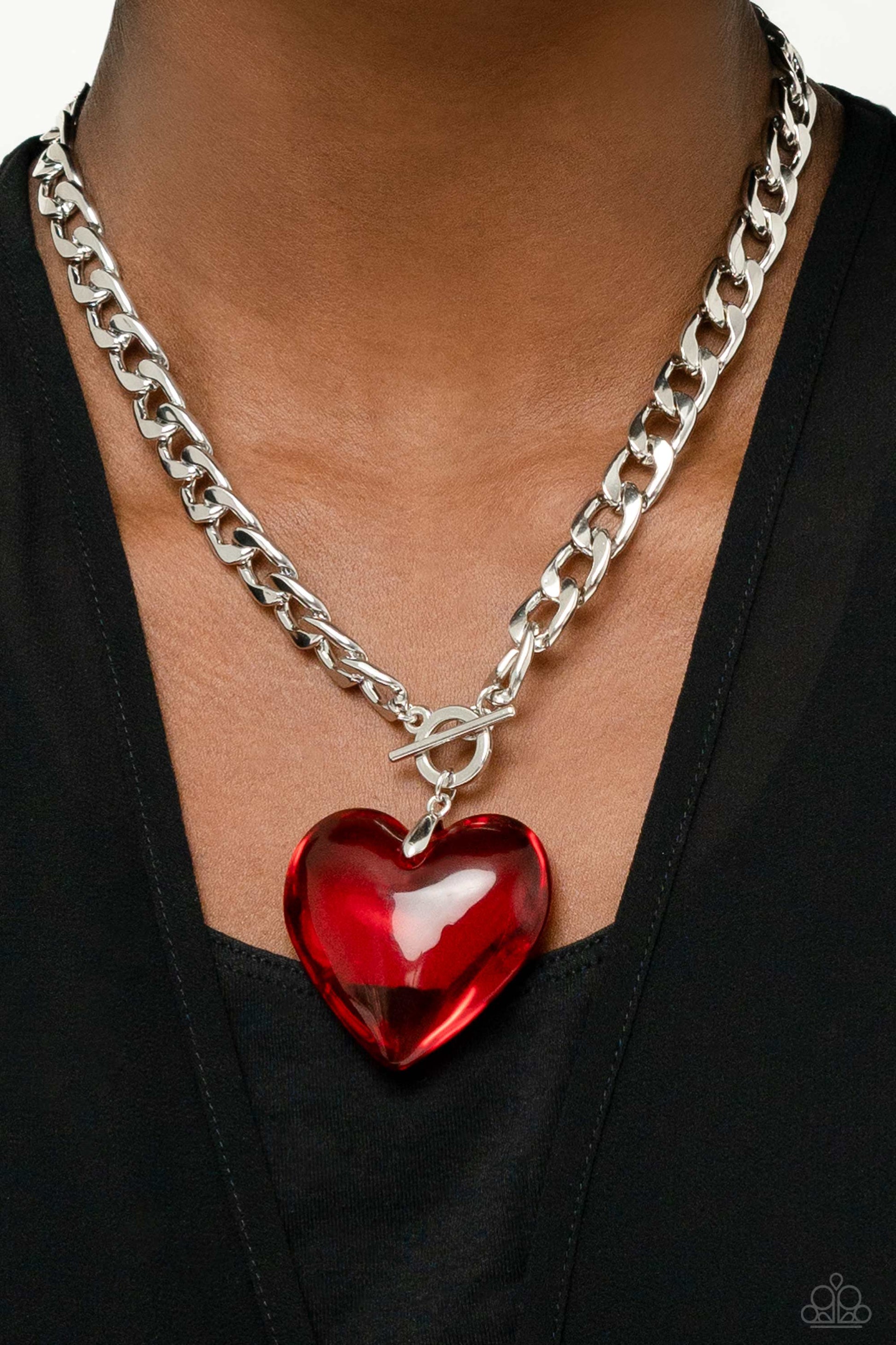 Paparazzi Accessories GLASSY-Hero - Red Featuring a glossy finish, an oversized, rich, red heart gem swings from the bottom of a thick silver curb chain below the collar for a romantic declaration. Features a toggle closure. Sold as one individual necklac