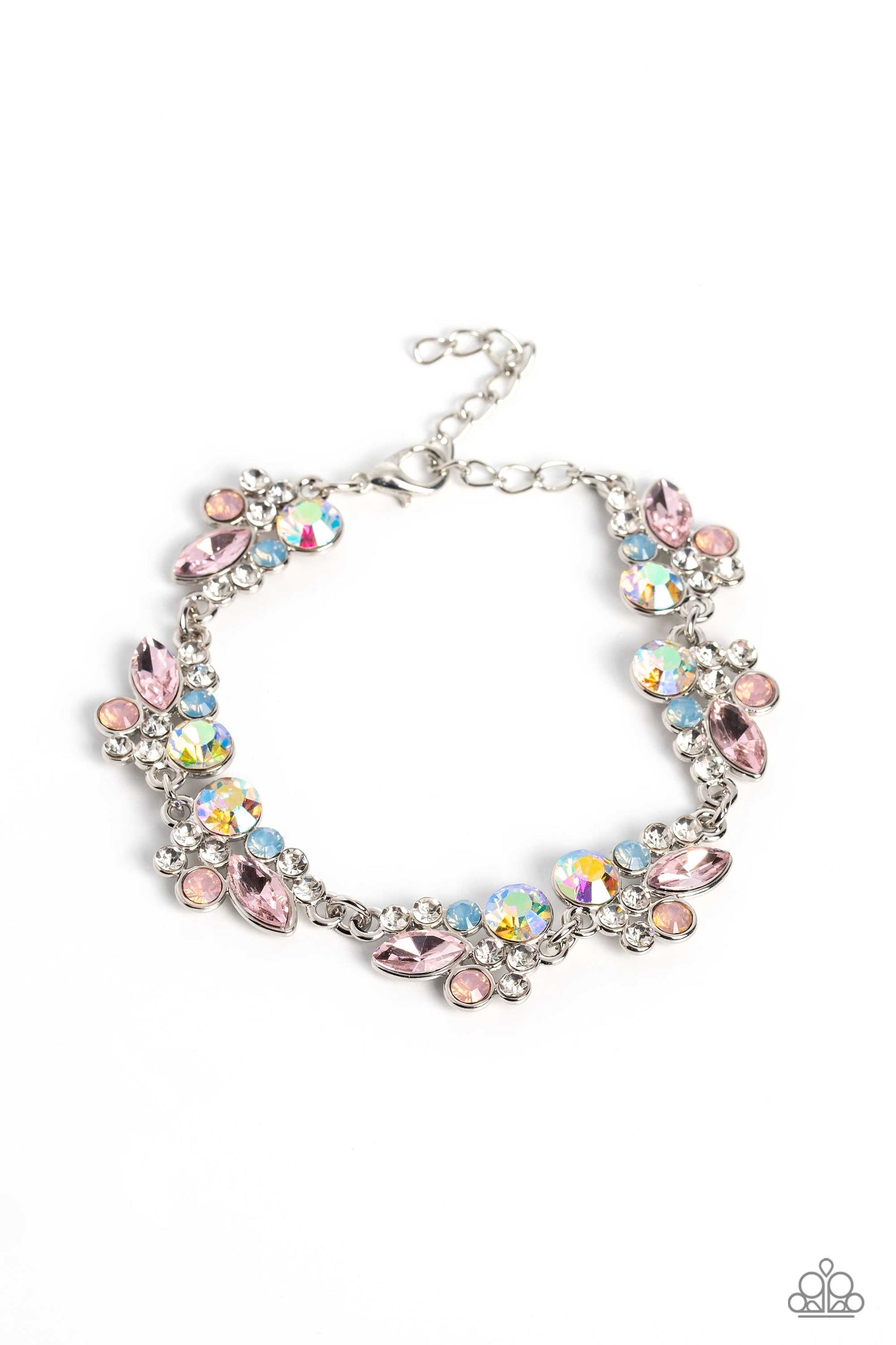 Paparazzi Accessories Poolside Perfection - Multi An eclectic collection of white, blue, iridescent and light peach round rhinestones in varying sizes and marquise-cut gems in a light pink shade cluster around the wrist in high-sheen silver frames. Patter