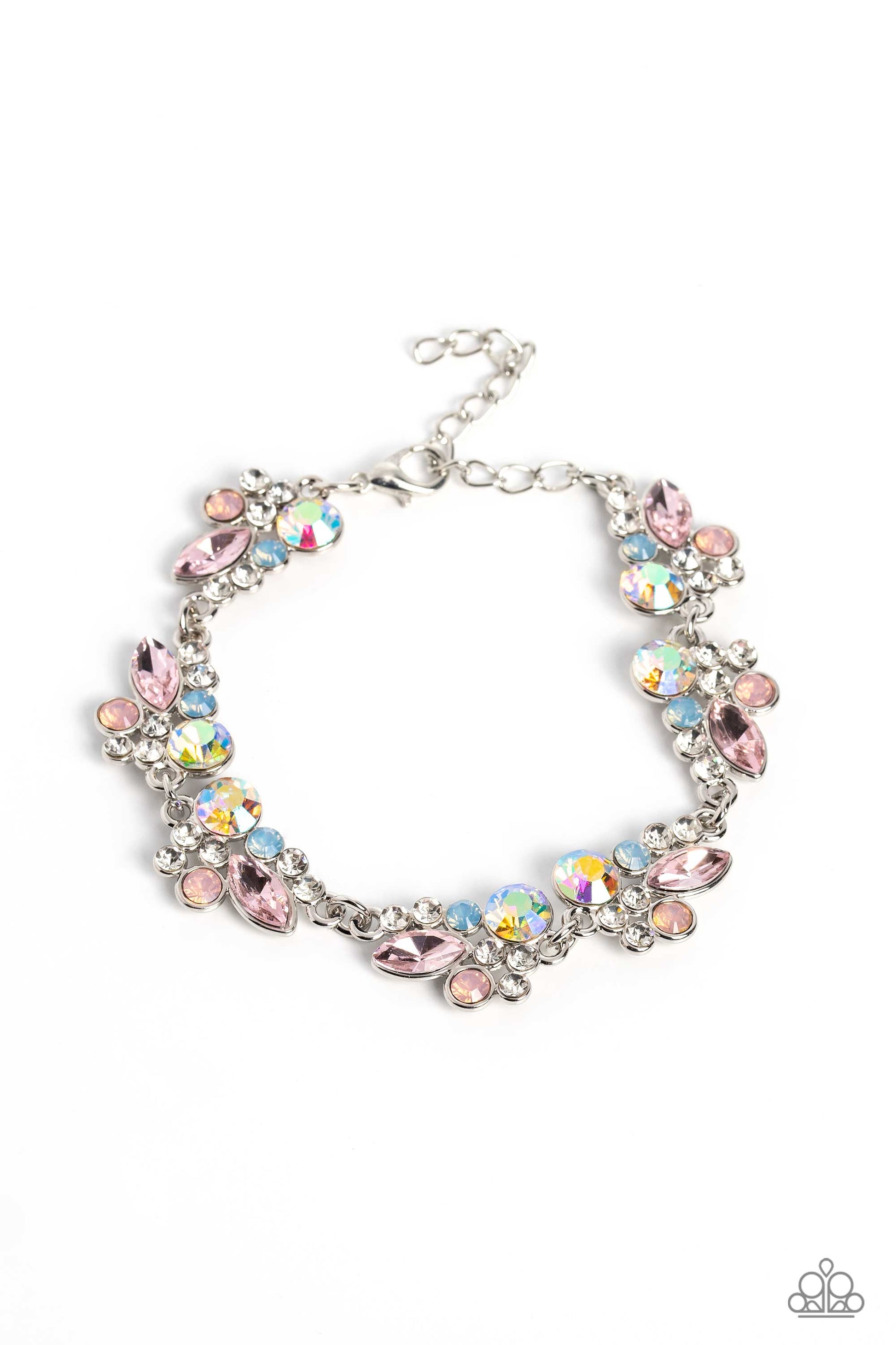 Paparazzi Accessories Poolside Perfection - Multi An eclectic collection of white, blue, iridescent and light peach round rhinestones in varying sizes and marquise-cut gems in a light pink shade cluster around the wrist in high-sheen silver frames. Patter