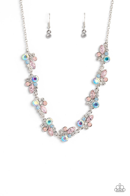 Paparazzi Accessories Swimming in Sparkles - Multi An eclectic collection of white, blue, iridescent and light peach round rhinestones in varying sizes and marquise-cut gems in a light pink shade cluster around the collar in high-sheen silver frames. Patt