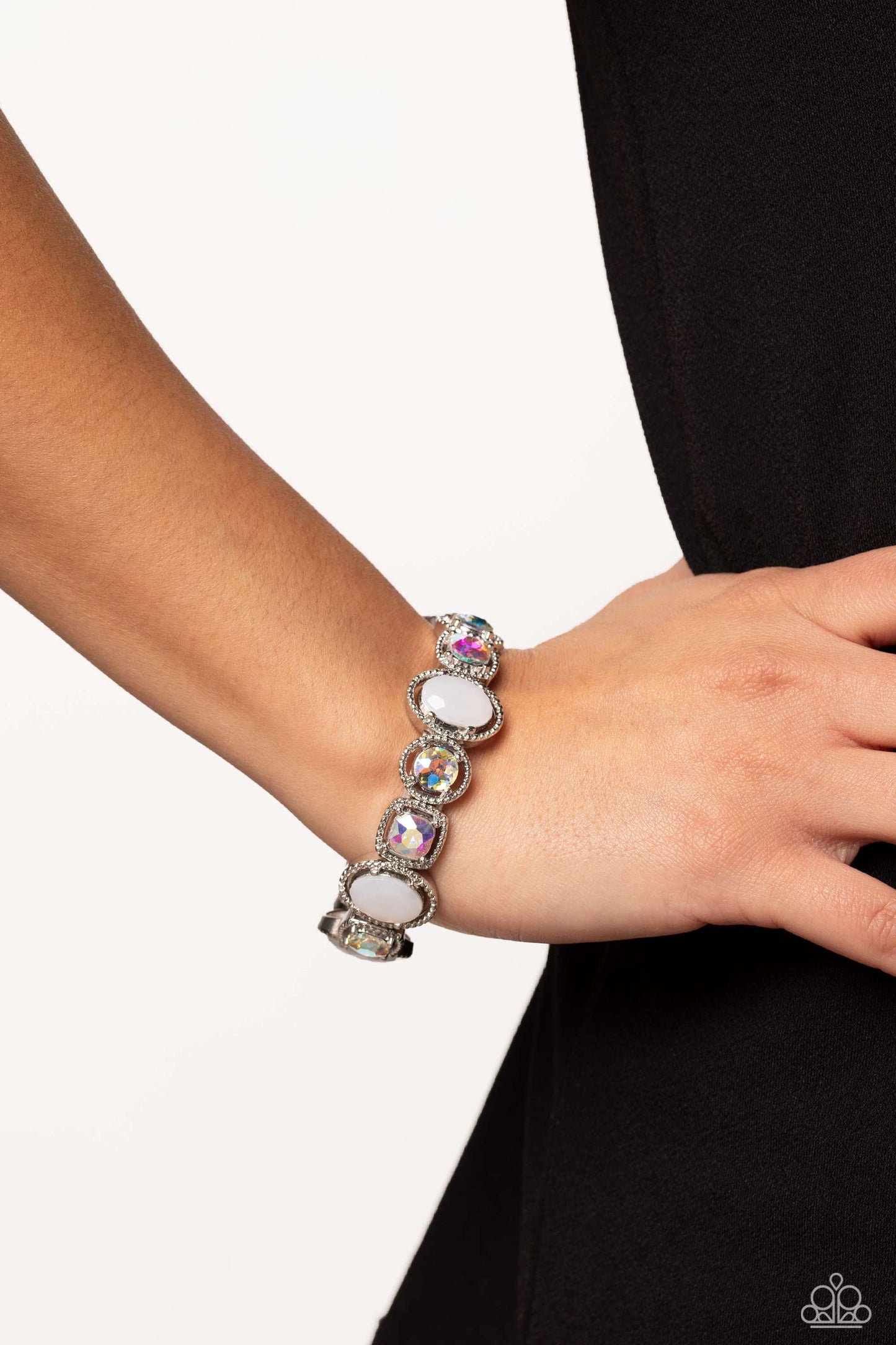 Paparazzi Accessories Fashion Fairy Tale - White Pressed in the center of pronged and studded thick silver oval, circular, and square frames, iridescent gems and milky white beads alternate around the wrist on elastic stretchy bands for a refined, geometr