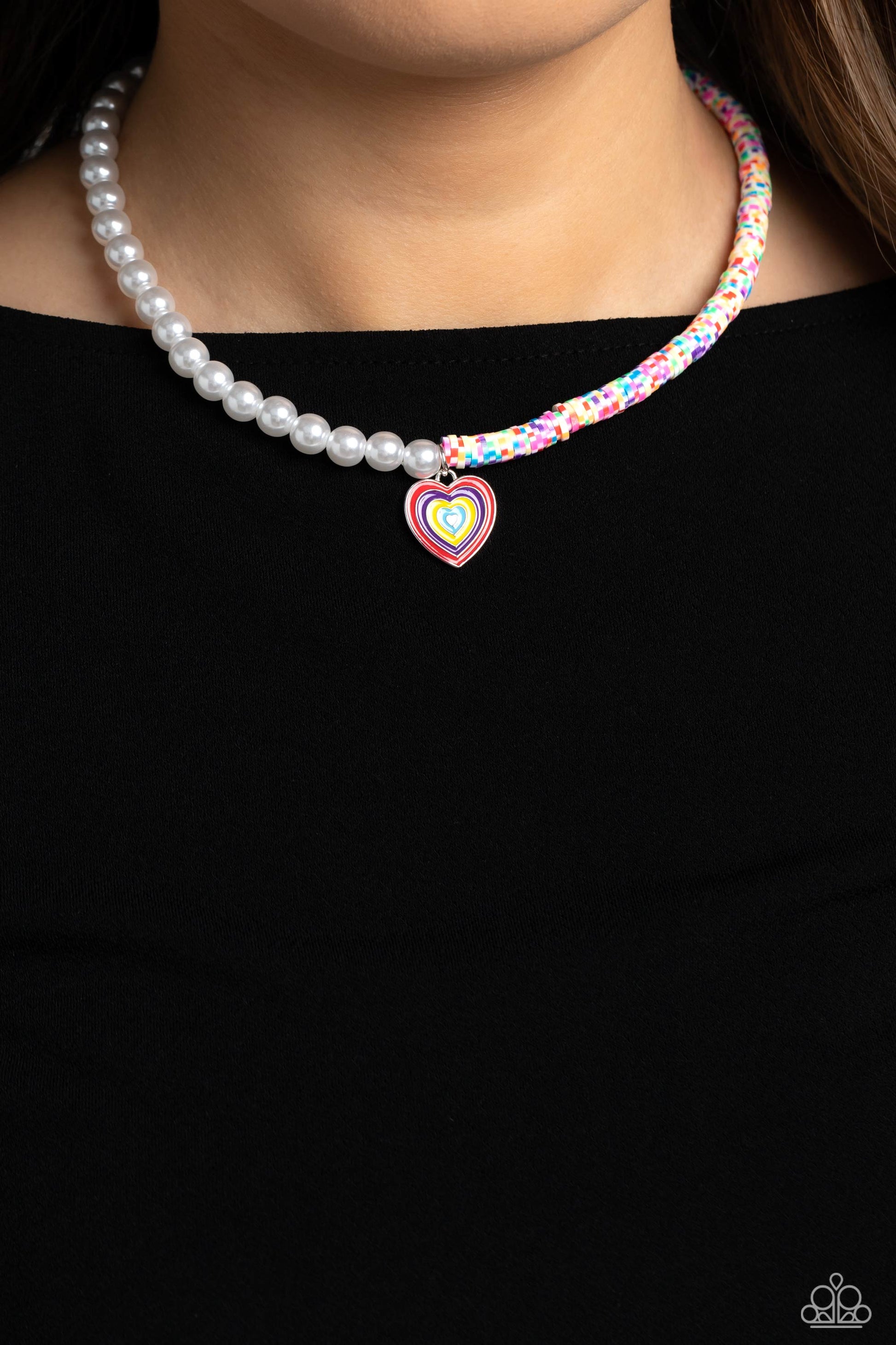 Paparazzi Accessories Precise Psychedelic - Multi A strand of gleaming white pearls and white clay discs striped with green, blue, purple, pink, red, orange, and yellow combine to create a half-and-half fashionable mashup down the neckline. A heart pendan