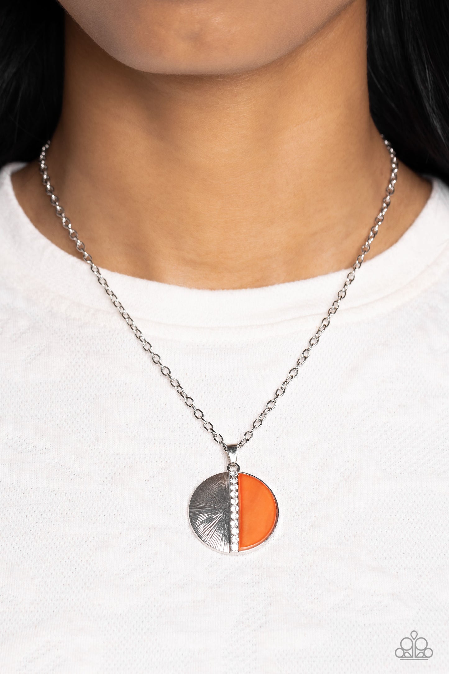 Paparazzi Accessories Captivating Contrast - Orange Embossed in radiant linear textures, a half-circle silver frame is nestled next to a half-circle coral shell for a colorful finish. White rhinestones dot down the center of the pendant for a spritz of gl