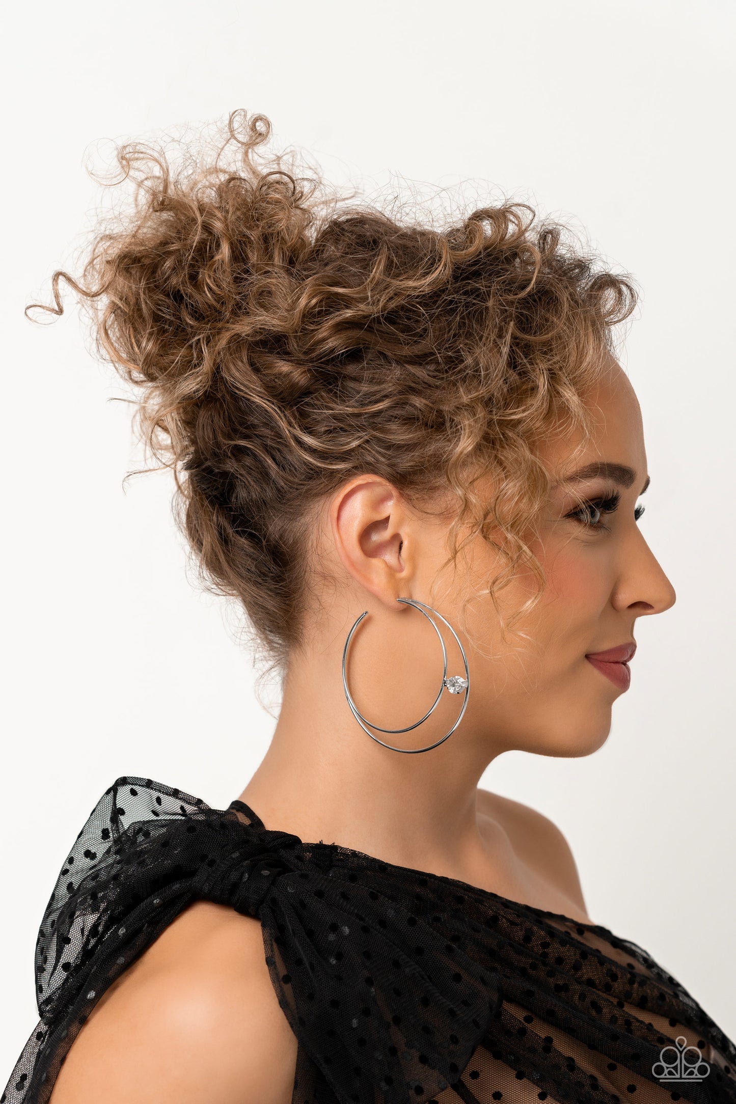 Paparazzi Accessories Theater HOOP - White Lodged between two dainty silver crescent frames that curve into double hoops, a faceted white rhinestone rests for a delicate shimmer near the ear. Earring attaches to a standard post fitting. Hoop measures appr