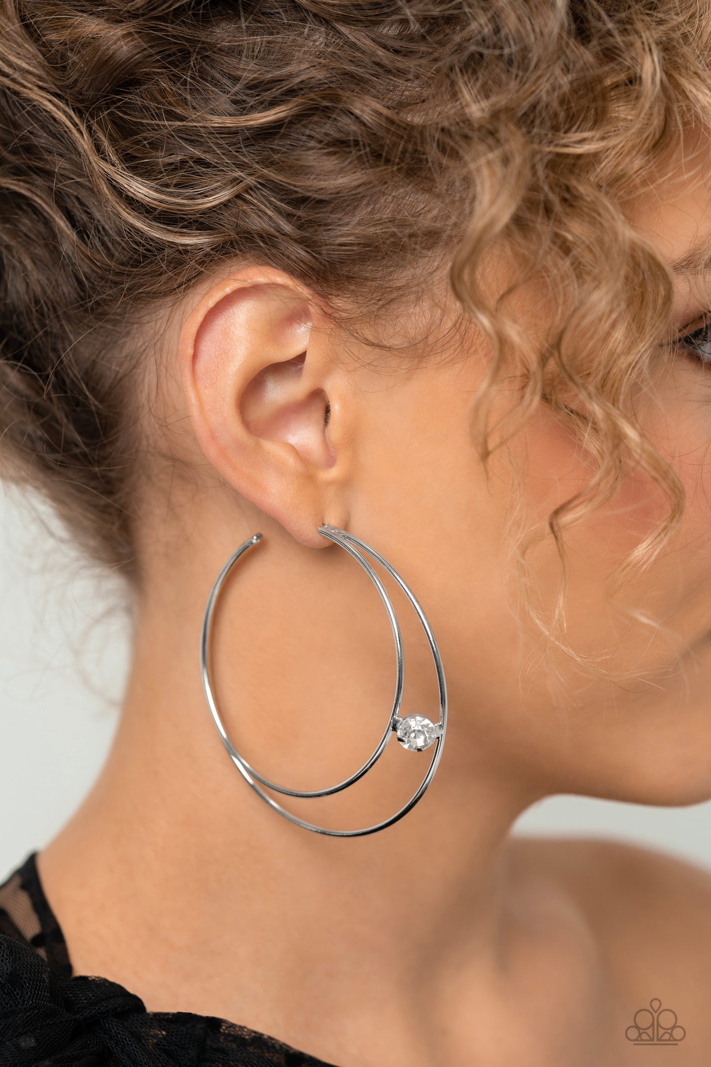 Paparazzi Accessories Theater HOOP - White Lodged between two dainty silver crescent frames that curve into double hoops, a faceted white rhinestone rests for a delicate shimmer near the ear. Earring attaches to a standard post fitting. Hoop measures appr