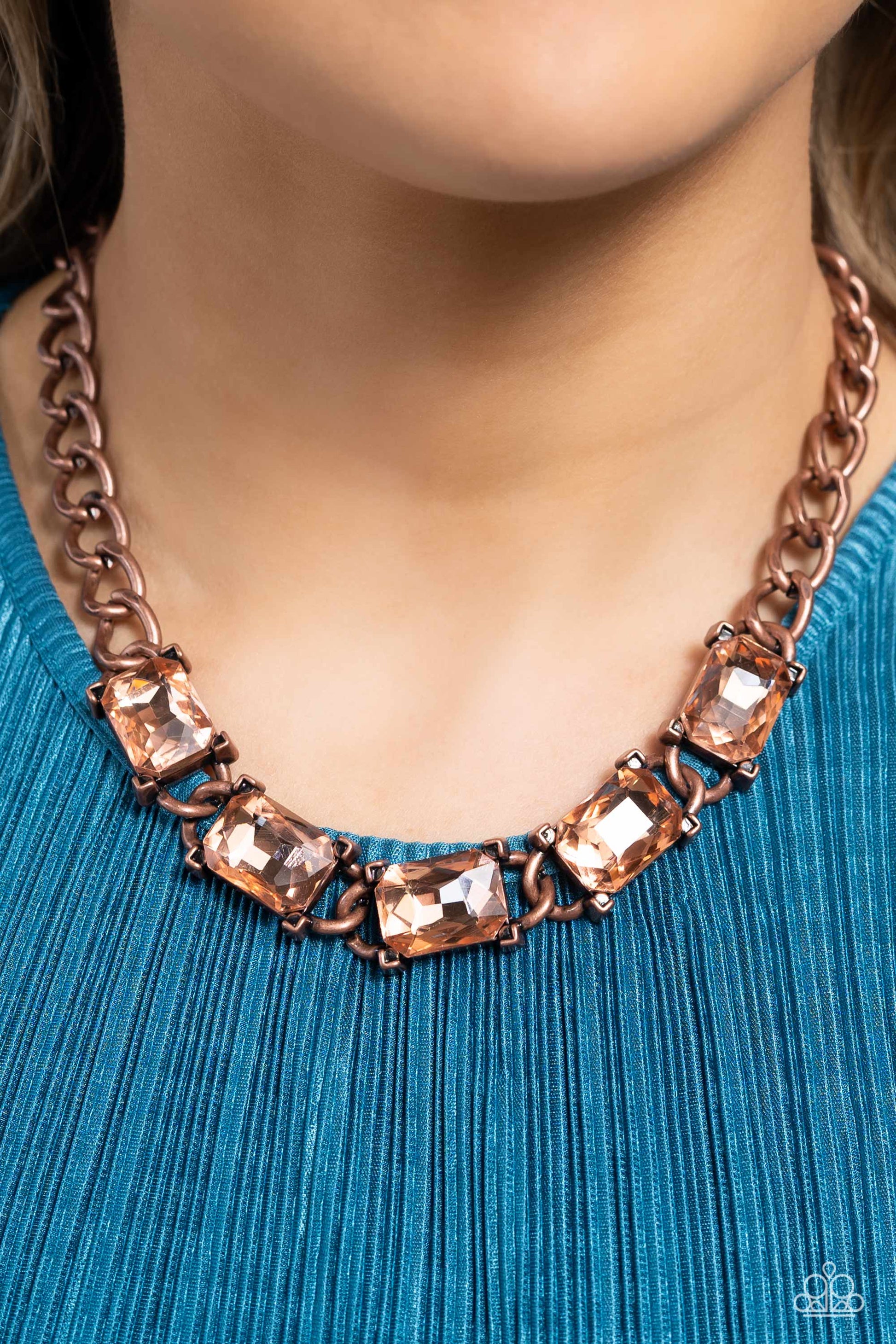 Paparazzi Accessories Radiating Review - Copper A succession of gleaming, radiant-cut, peachy gems encased in thick copper frames, coalesces around the neckline on a thick copper curb chain for an edgy statement. Features an adjustable clasp closure. Sold
