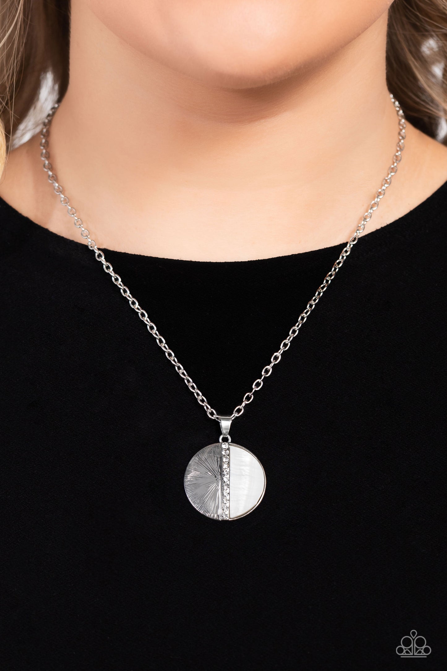 Paparazzi Accessories Captivating Contrast - White Embossed in radiant linear textures, a half-circle silver frame is nestled next to a half-circle white shell for a colorful finish. White rhinestones dot down the center of the pendant for a spritz of gli