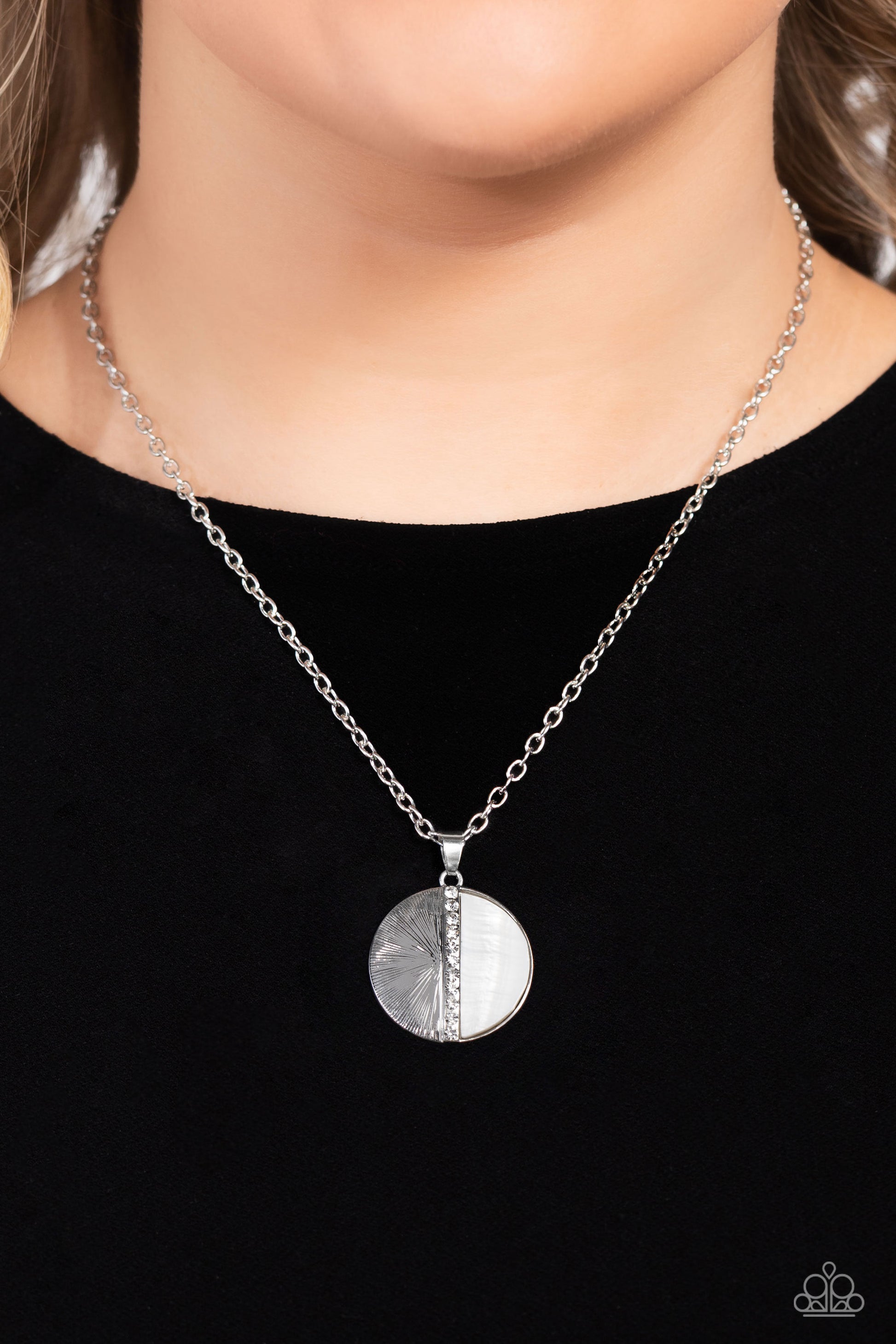 Paparazzi Accessories Captivating Contrast - White Embossed in radiant linear textures, a half-circle silver frame is nestled next to a half-circle white shell for a colorful finish. White rhinestones dot down the center of the pendant for a spritz of gli