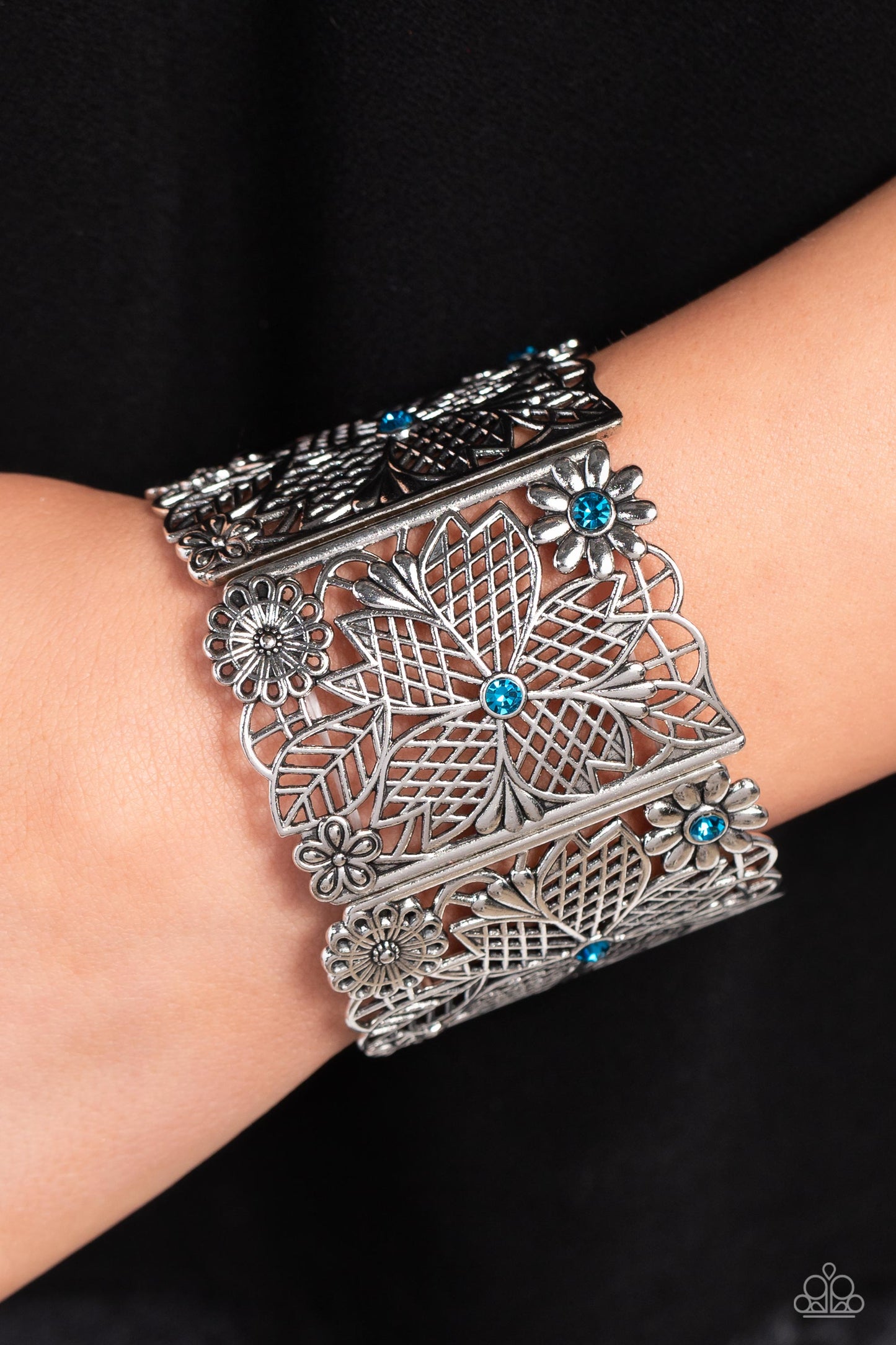Paparazzi Accessories Garden City - Blue Featuring blue rhinestone centers, rectangular intricate, floral, filigree-filled silver frames are threaded along a stretchy band around the wrist for a whimsical garden-inspired look. Sold as one individual brace
