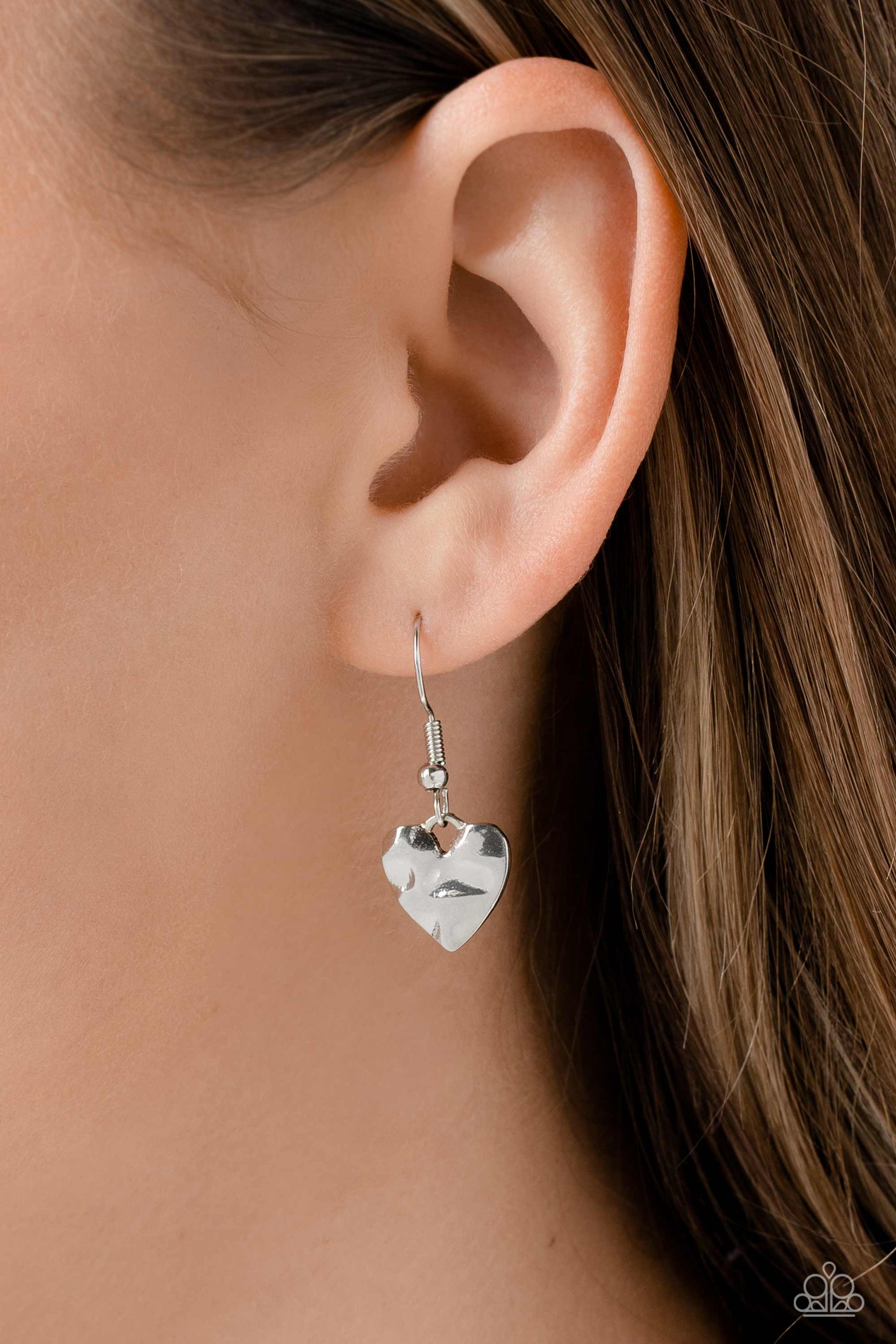Paparazzi Accessories Confident Courtship - Red An oversized, silver heart pendant featuring a hammered sheen, falls down the neckline at the end of red cording for an alluring appeal. Features an adjustable clasp closure. Sold as one individual necklace.