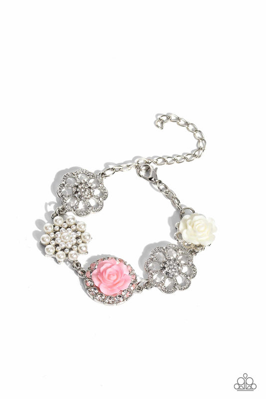 Paparazzi Accessories Tea Party Theme - Pink A collection of whimsical, refined flowers gathers along a flat, sleek silver link chain. The featured charms include an ivory resin rose blooming atop a glittery silver floral silhouette, two silver flowers du