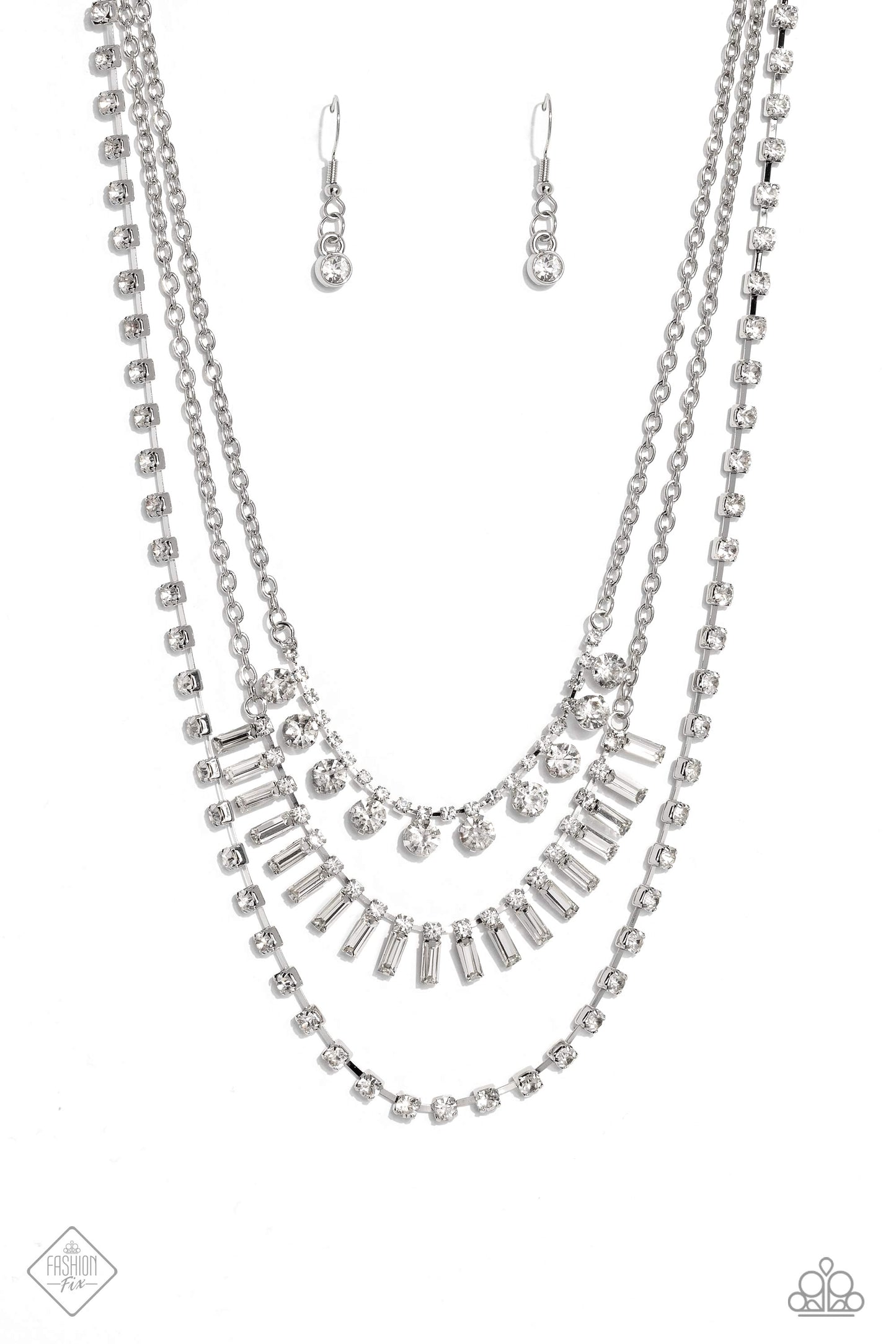 Paparazzi Accessories Dripping in Stardust - White Three silver chains fall into haphazard layers across the chest, creating a radiantly edgy display. On the uppermost chain, a row of solitaire rhinestones emerges from a section of small, white, square-cu