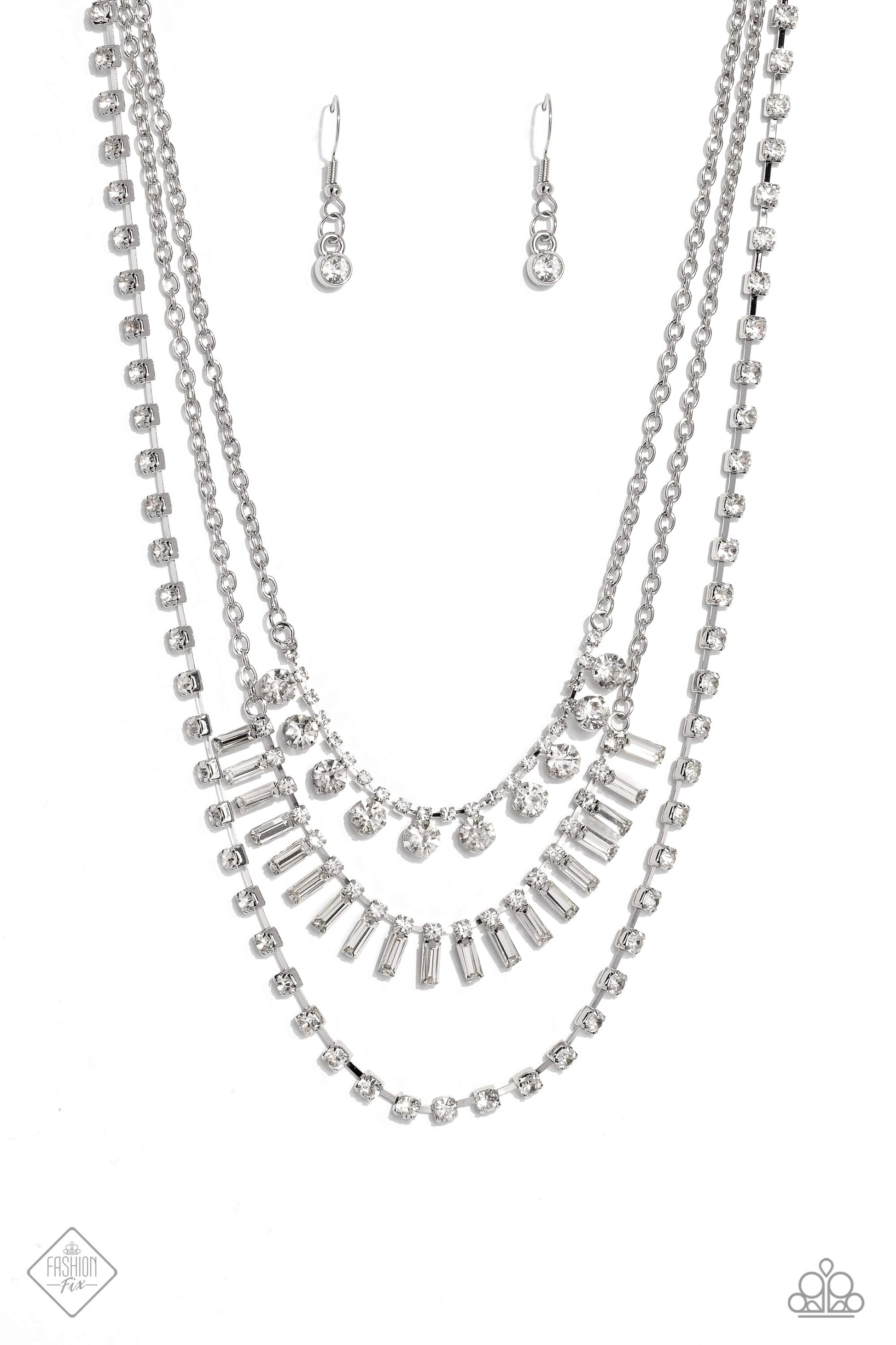 Paparazzi Accessories Dripping in Stardust - White Three silver chains fall into haphazard layers across the chest, creating a radiantly edgy display. On the uppermost chain, a row of solitaire rhinestones emerges from a section of small, white, square-cu