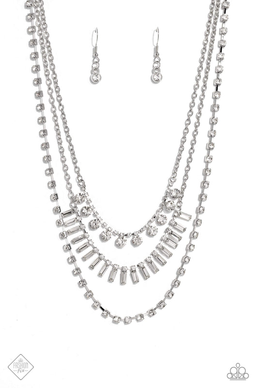 Paparazzi Accessories Dripping in Stardust - White Three silver chains fall into haphazard layers across the chest, creating a radiantly edgy display. On the uppermost chain, a row of solitaire rhinestones emerges from a section of small, white, square-cu