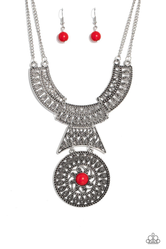 Paparazzi Accessories Fetching Filigree - Red Rows of oversized silver filigree frames stack into a crescent-shape that is anchored by additional silver filigree frames that layer down the neckline. Featured in the center of the lowermost circular frame,