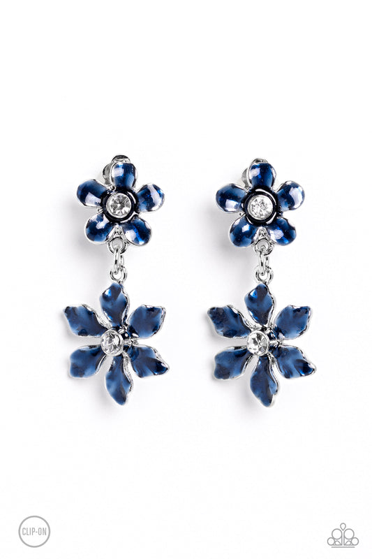 Paparazzi Accessories Transparent Talent - Blue *Clip-On A navy transparent flower with pinched petals blooms around a glittery white gem center. The large flower swings from a second transparent navy flower, featuring a smaller size with fanned-out petal