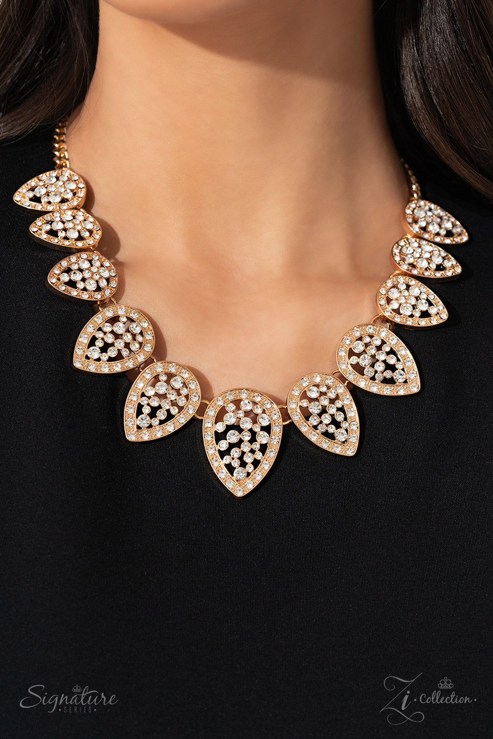 Paparazzi Accessories The Cody Gold teardrops are dusted in white rhinestones and flipped upside down, fanning out along the collar in a glittery display. Increasing in size as they lead to the center, each teardrop sparkles intensely, showcasing its pris