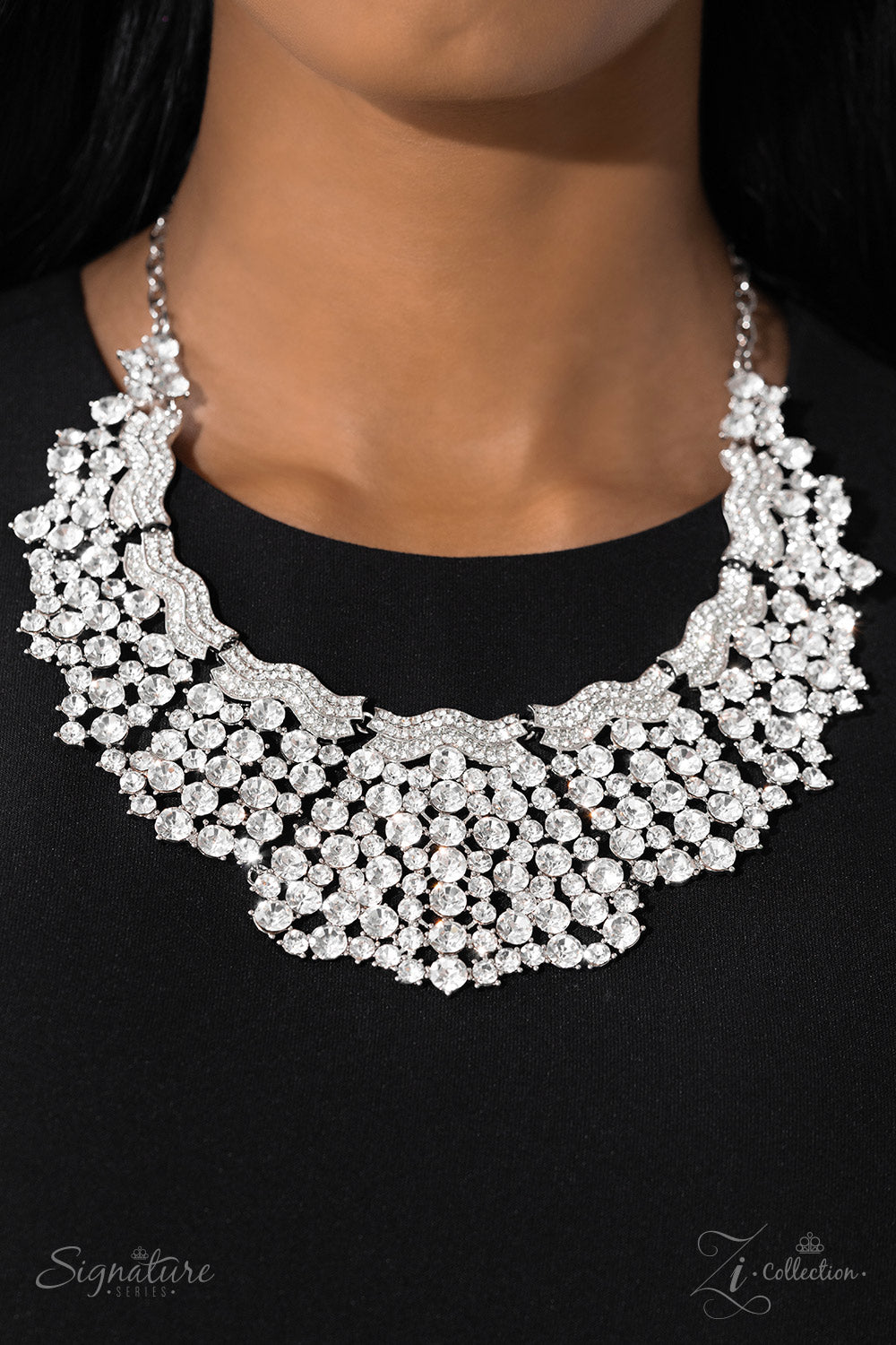 Paparazzi Accessories The DEtta Wavy silver bars, encrusted in white rhinestones, create a striking silhouette as they fall along the neckline. An explosion of sparkle erupts below the brilliant bands, with countless white rhinestones strategically stagge