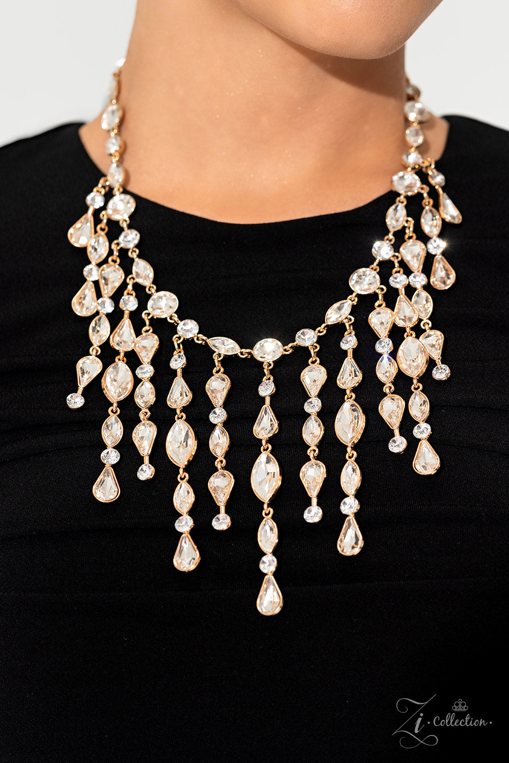 Paparazzi Accessories Alluring - Gold A stunning array of glitzy, white rhinestones are pressed into radiant gold frames, linking around the collar in vintage resplendence. The strand of round and marquise-cut gems gives way to a fringe of uncompromising