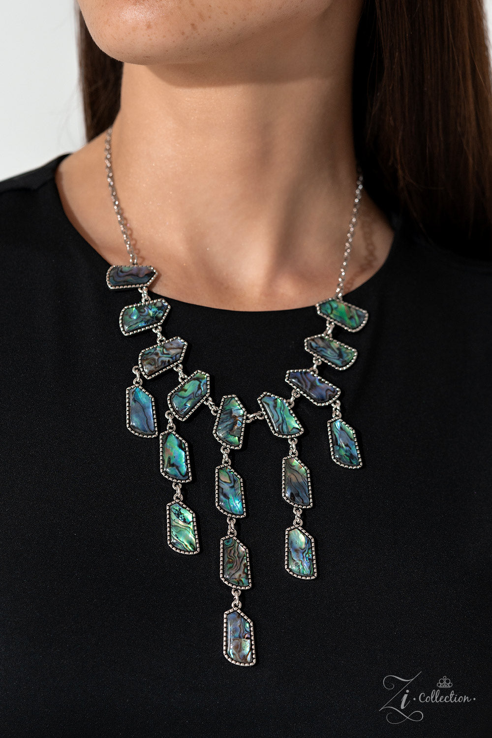 Paparazzi Accessories Reverie - Multi Abalone shells swirled in dreamy, reflective hues of blue, purple, and green are cut into abstract geometric shapes and set into studded silver frames. Silver chain links connect a row of shells that bows along the ne